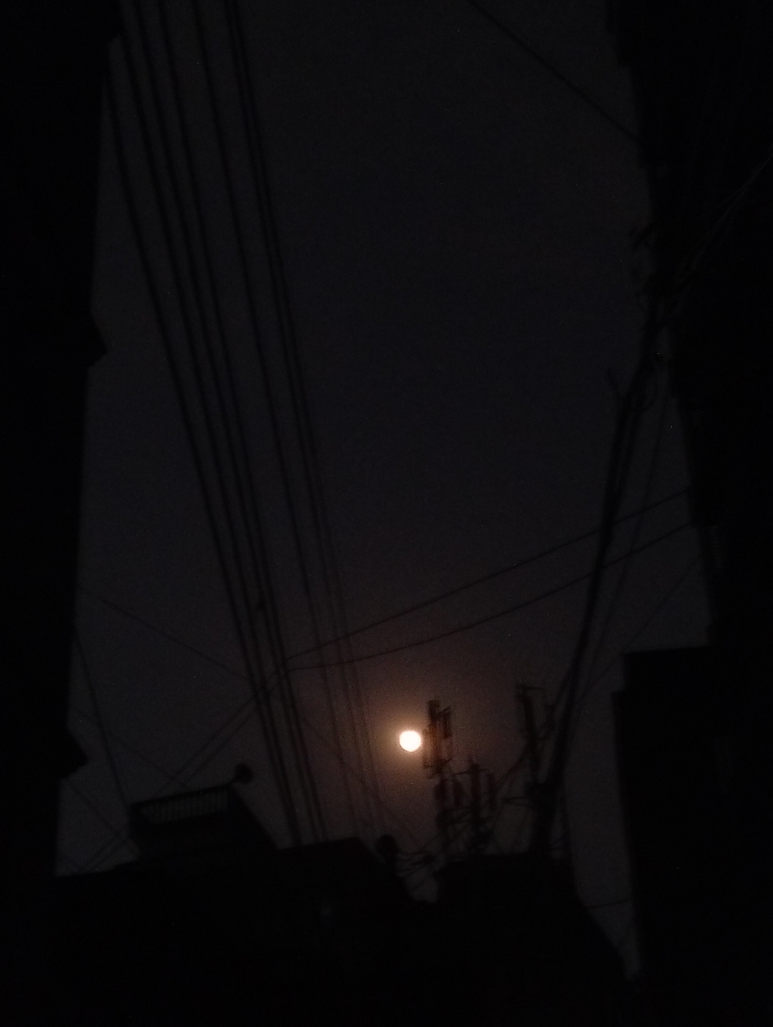Telecommunications tower photographed at night in Dhaka