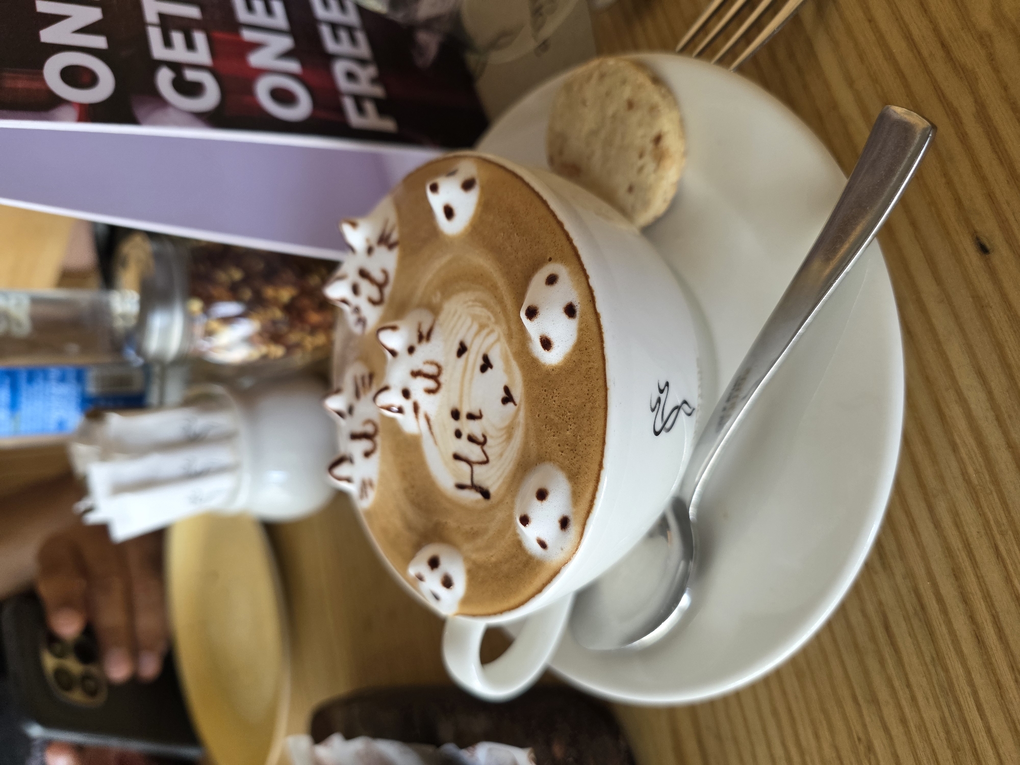 Cat-face latte art on a wooden table in Mumbai