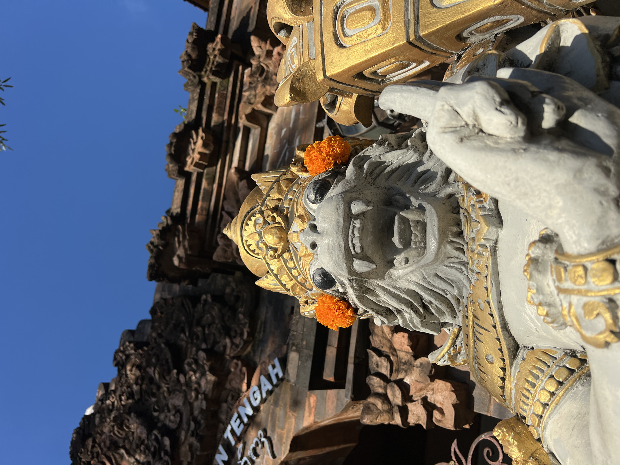 Temple visit documented in Kuta with traditional offerings, statues