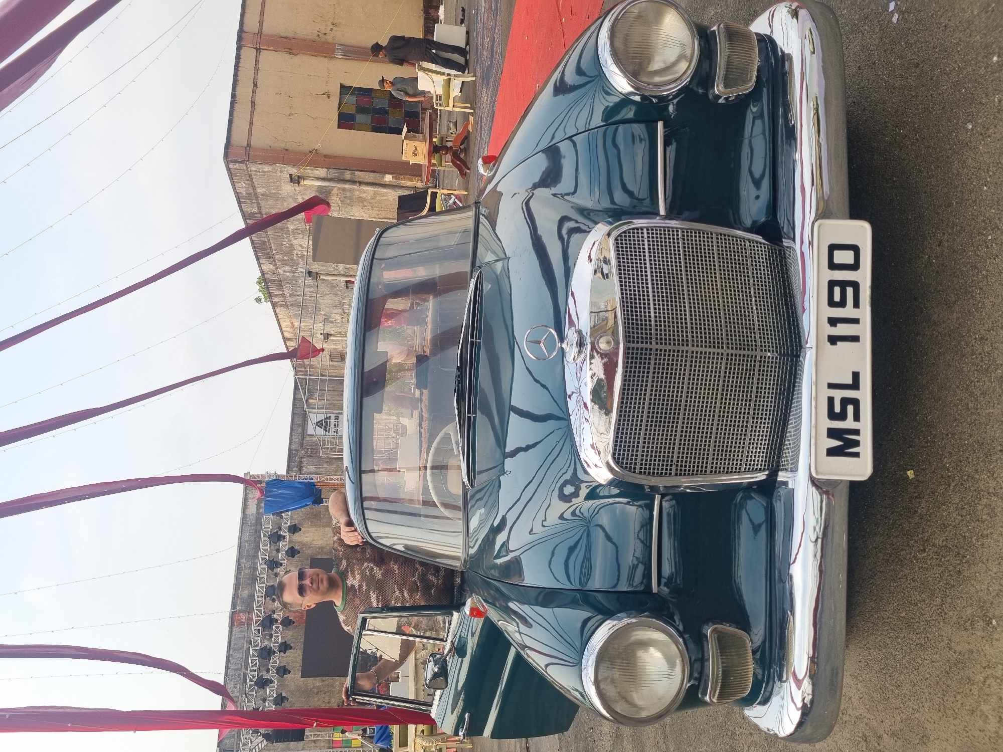 Vintage Mercedes spotted with door open, man in sunglasses