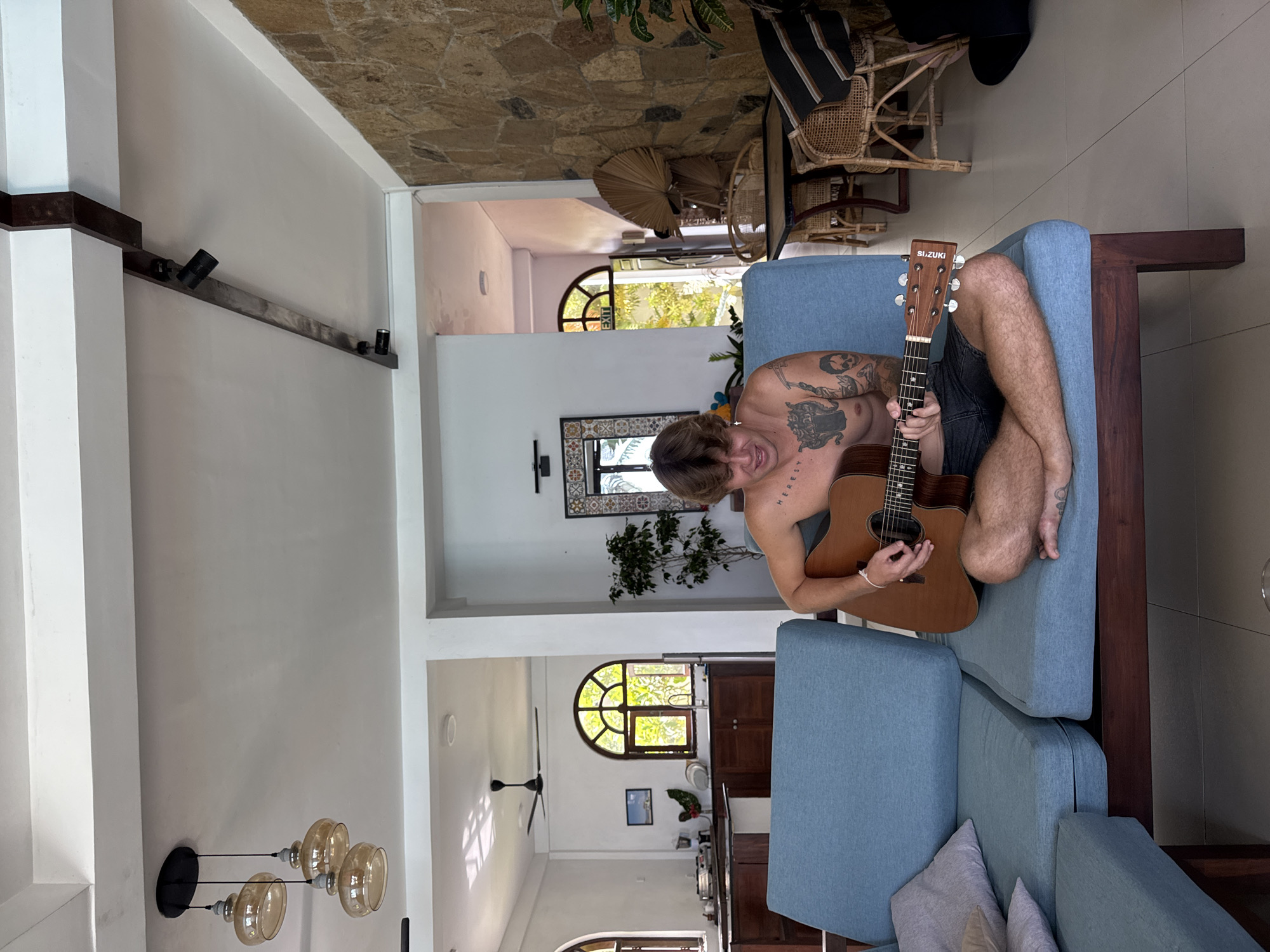 Acoustic guitar session on a blue sofa, Goviyapana