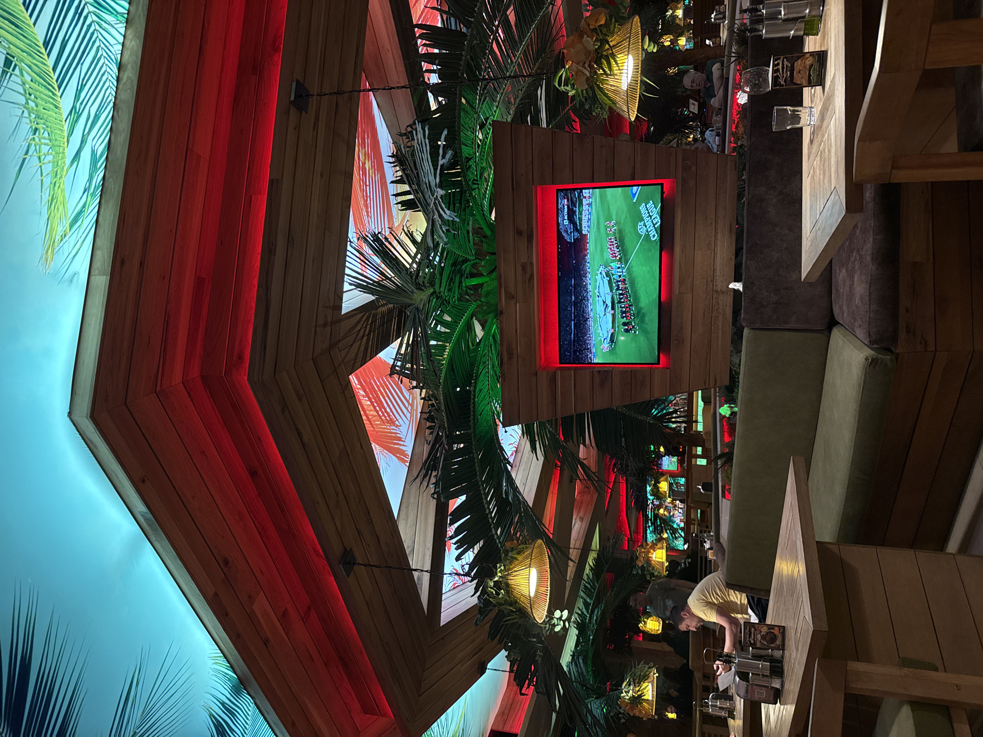 Sofia resident documents local bar interior, aircraft contrails overhead