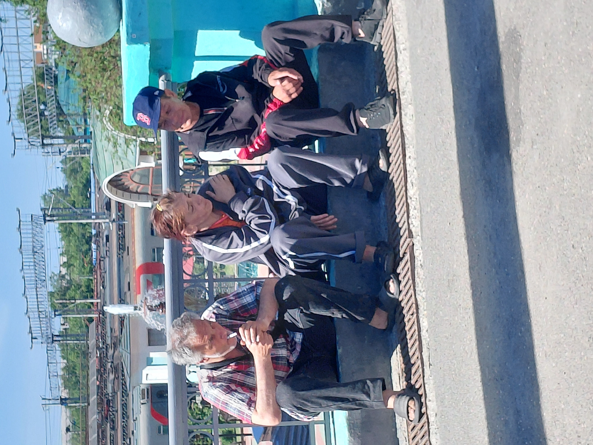 A Russian suburban train station buzzing with midday activity