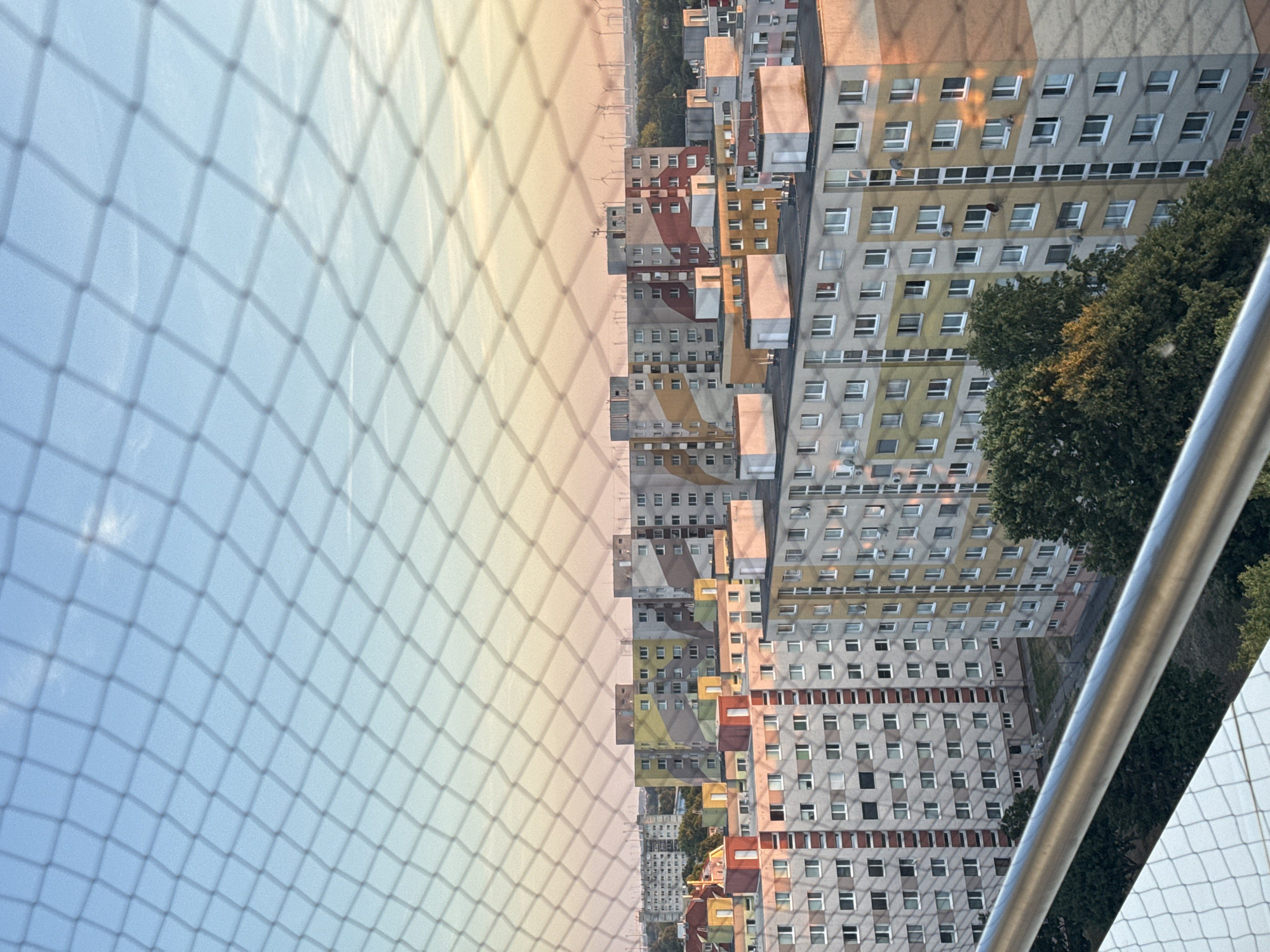 Balcony reading session above Bratislava's rooftops at sunset
