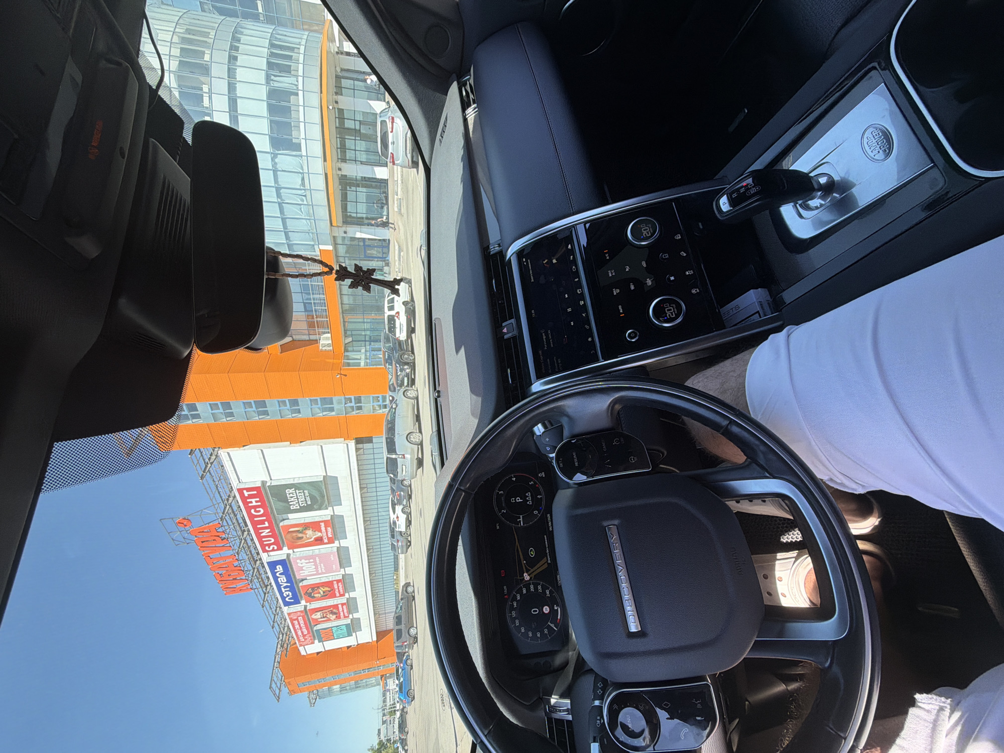 Driver navigates Land Rover through sunny Krasnoyarsk morning
