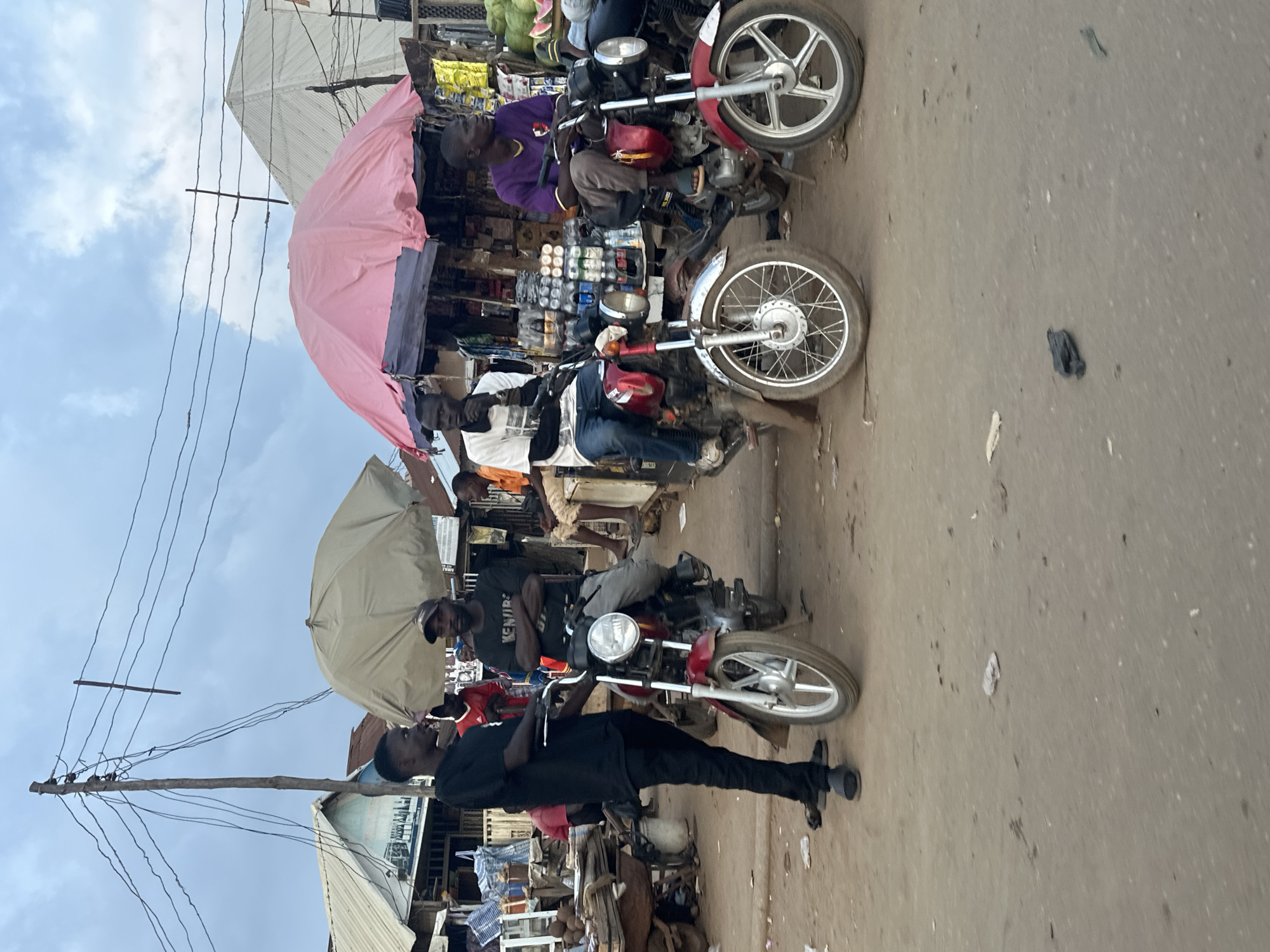 Street market activity and Keke Napep in Abuja afternoon