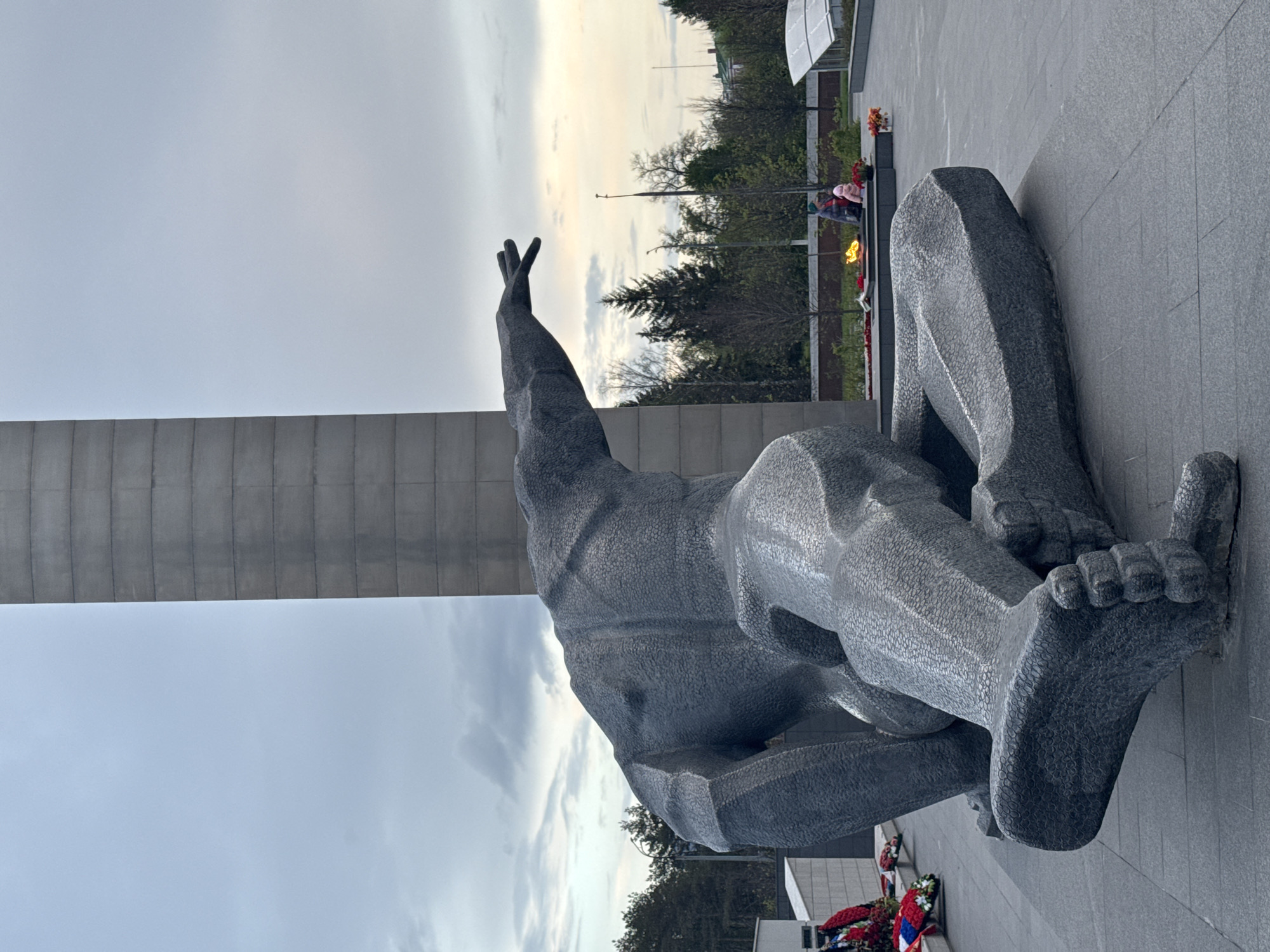 Visitor documents war memorial sculptures and eternal flame in Kazan