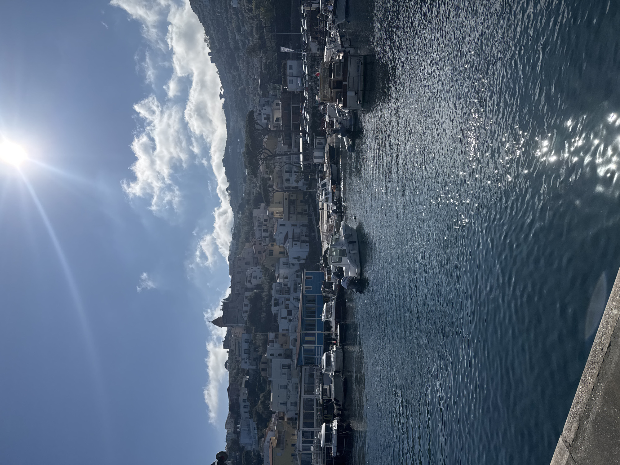 Morning sunlight illuminates Massa Lubrense port in Italy