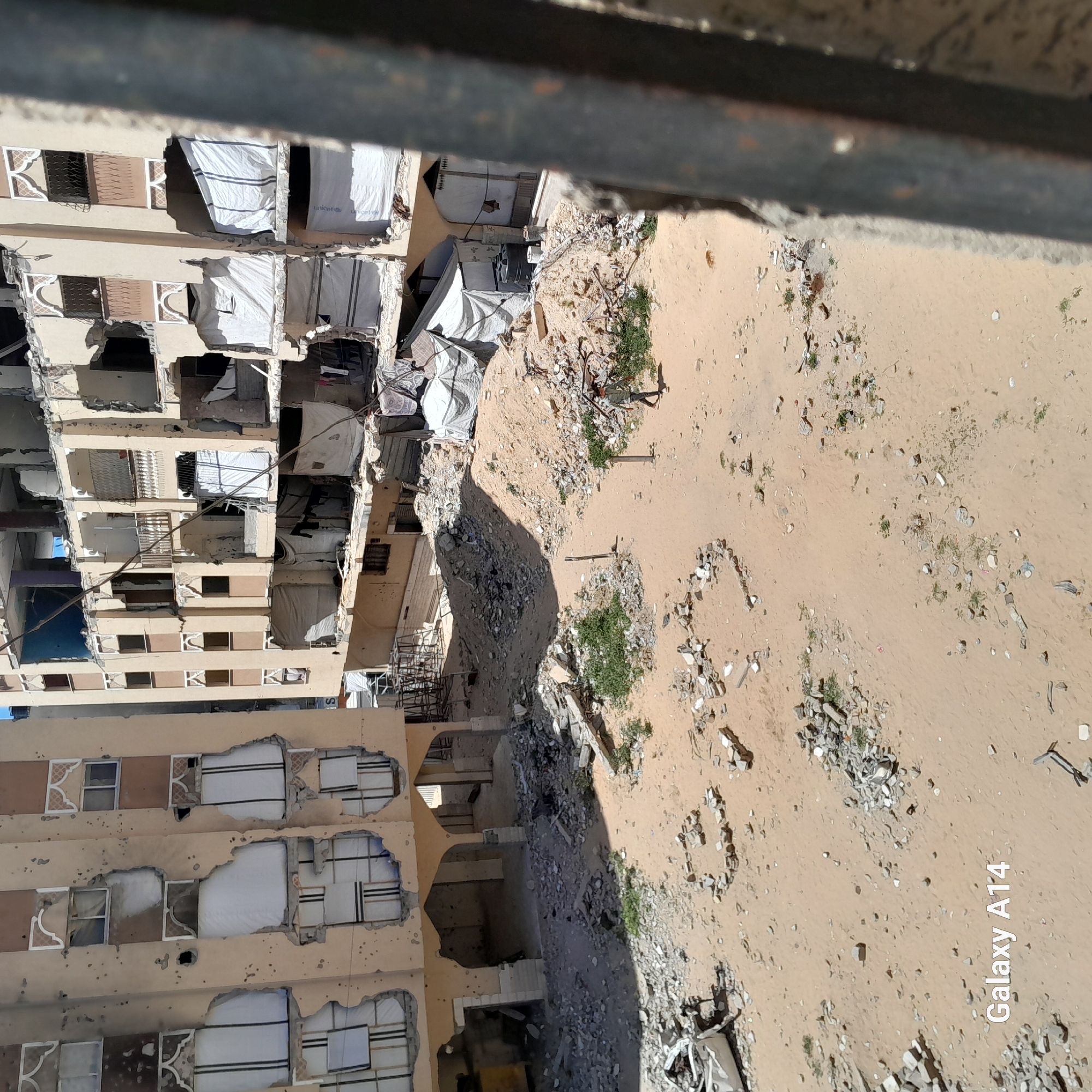 Damaged buildings documented in Khan Yunis amid daily life