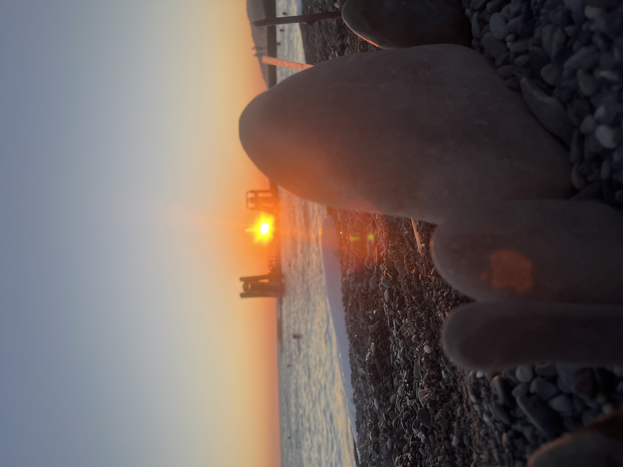 Black Sea beach sunset in Sochi, with swimming, parasailing, and inflatables