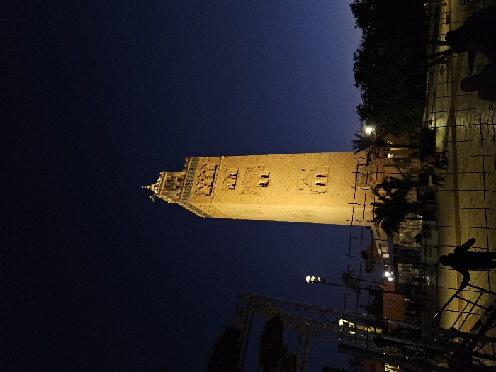 Evening stroll captures illuminated Koutoubia Mosque in Marrakesh twilight