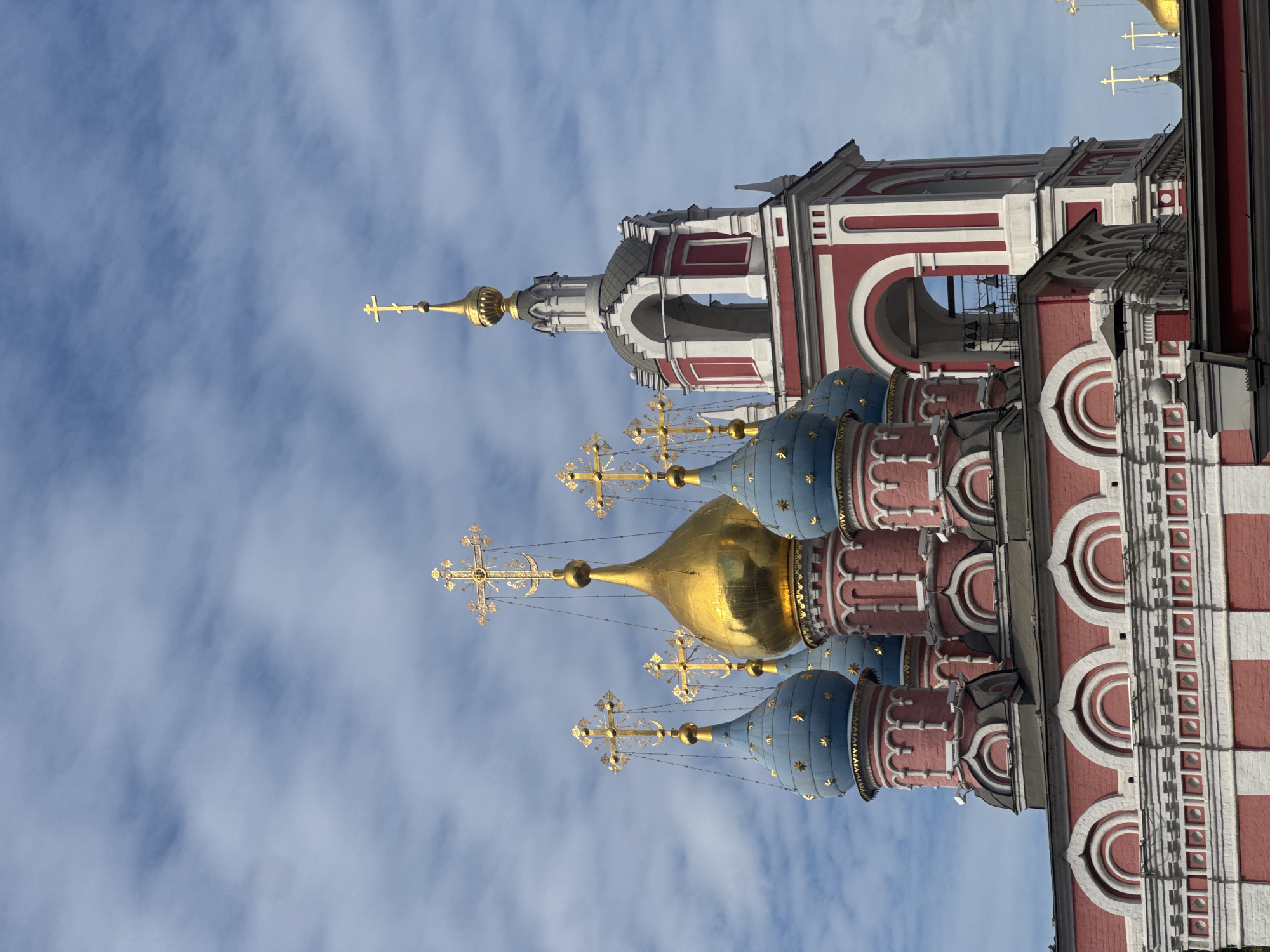 Kadashi church's pink and white facade under cloudy Moscow skies