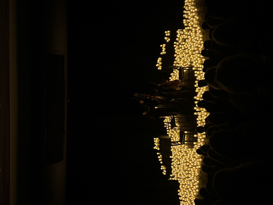 Musicians perform by candlelight in pre-dawn Whistler gathering
