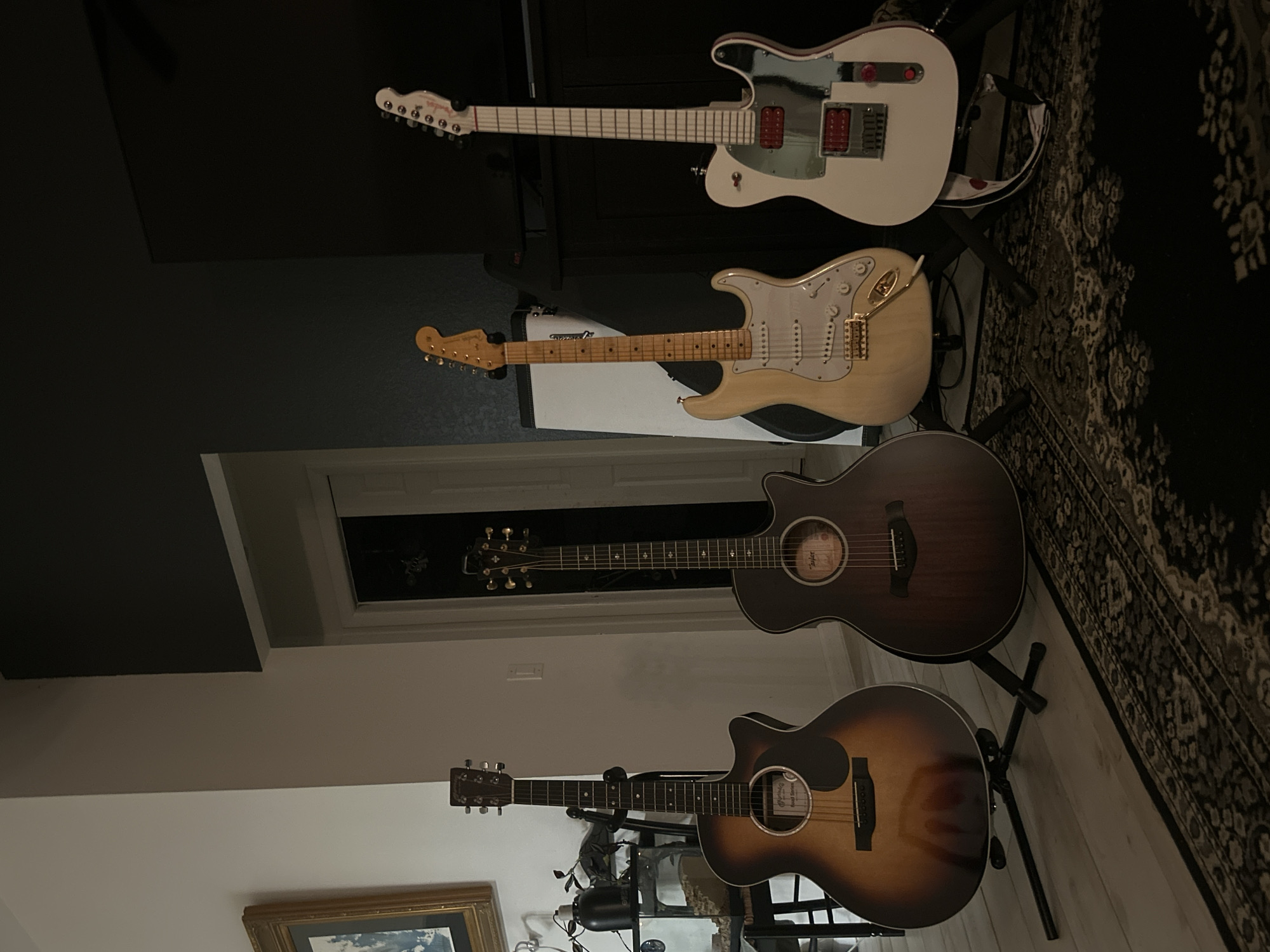 Four guitars displayed on stands in Cape Coral home