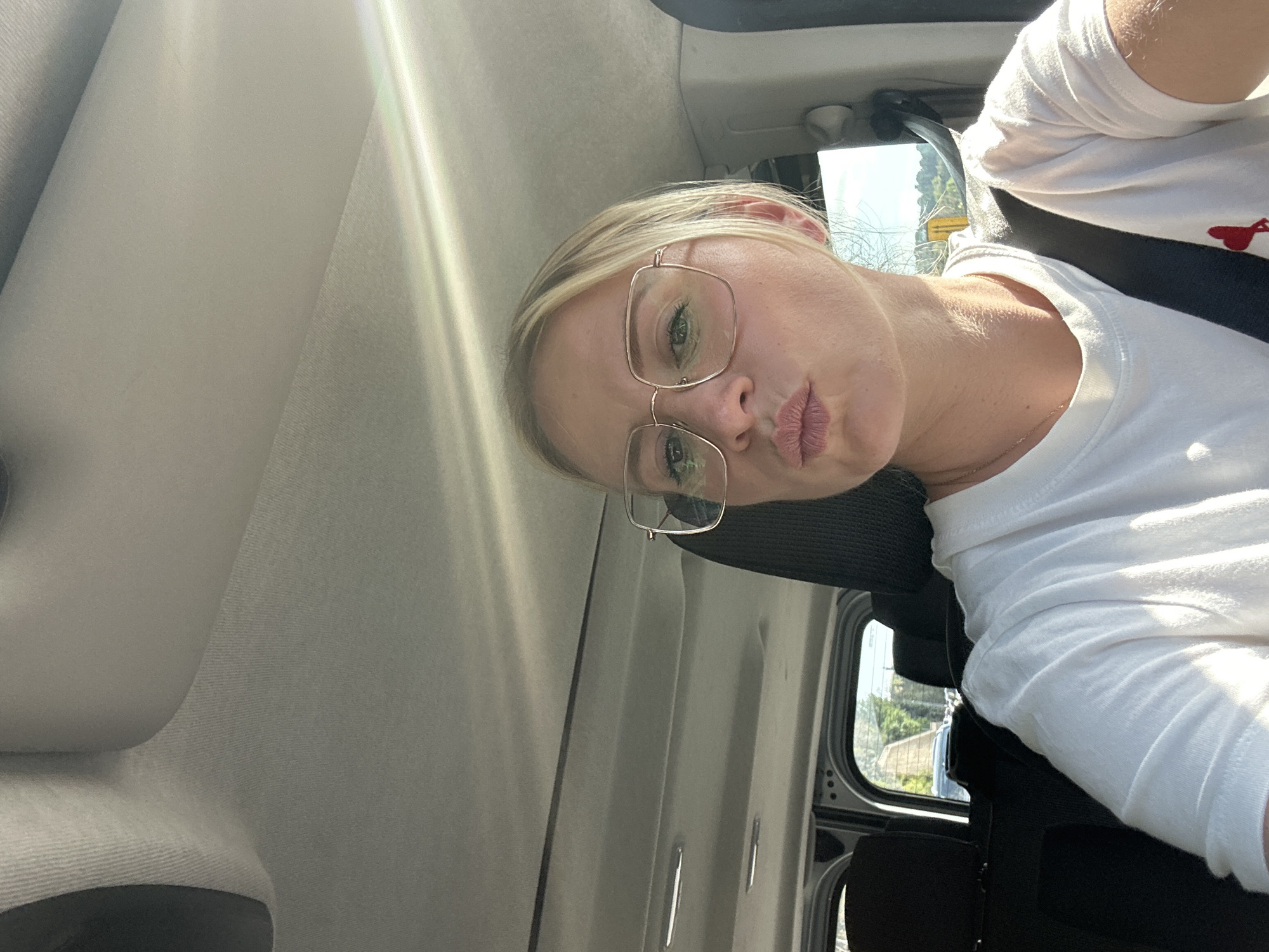 Woman playfully sticks tongue out while traveling in Antibes