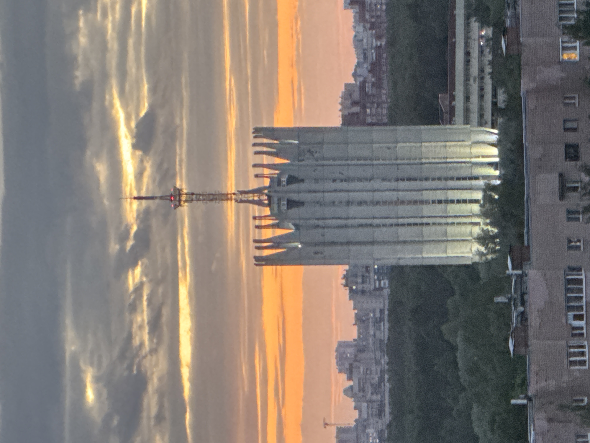 Urban sunset documented with communication tower silhouetted against colorful sky