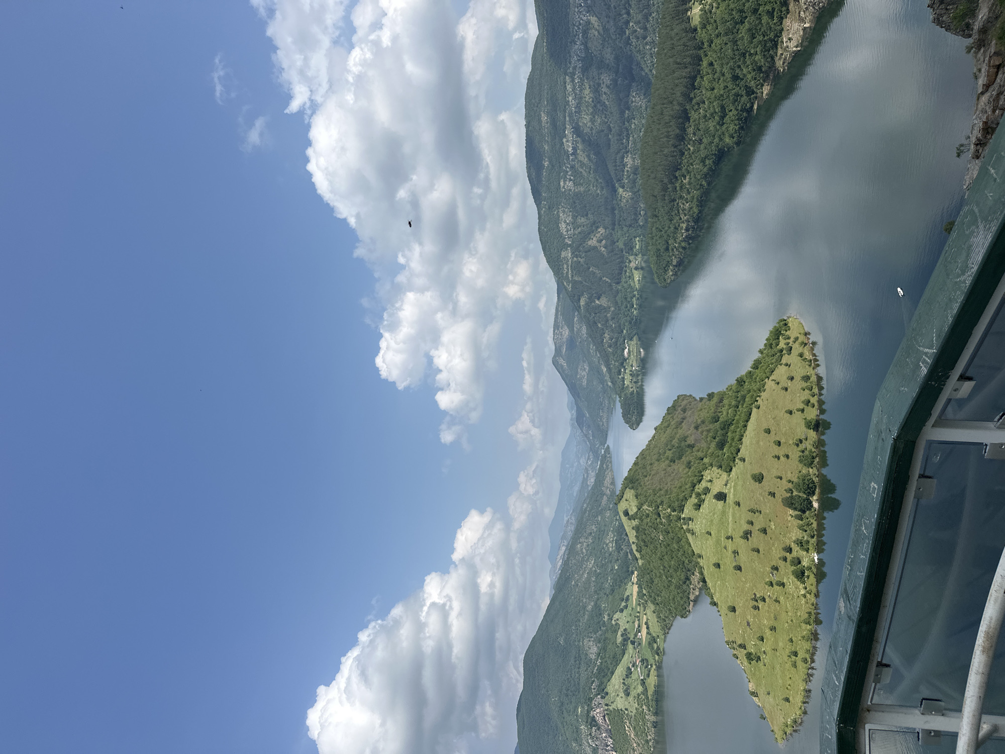 Tourist documents scenic reservoir views across Bulgarian mountains