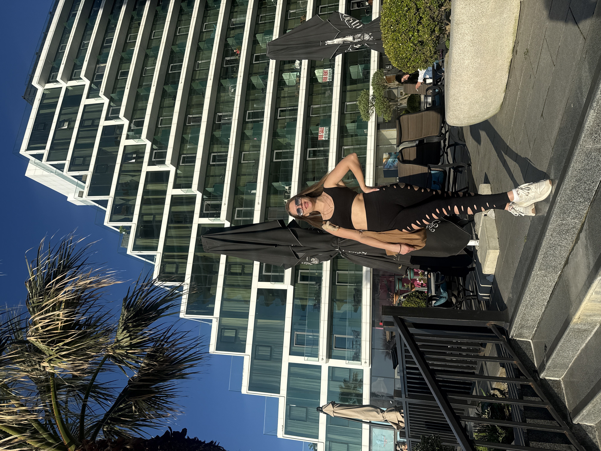 Woman in athletic wear spotted near modern building in Batumi