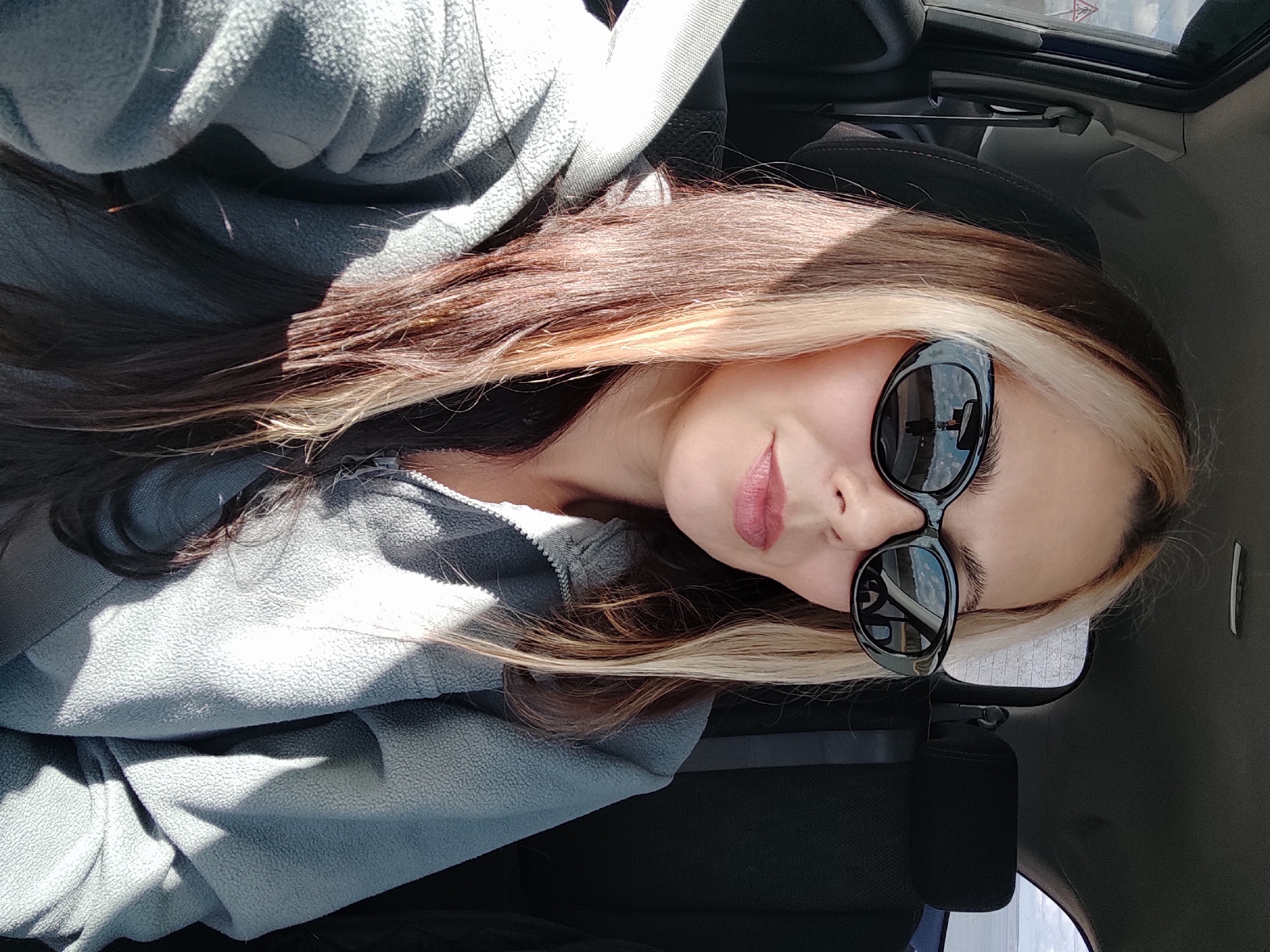 Woman takes car selfie in Noviy, Russia