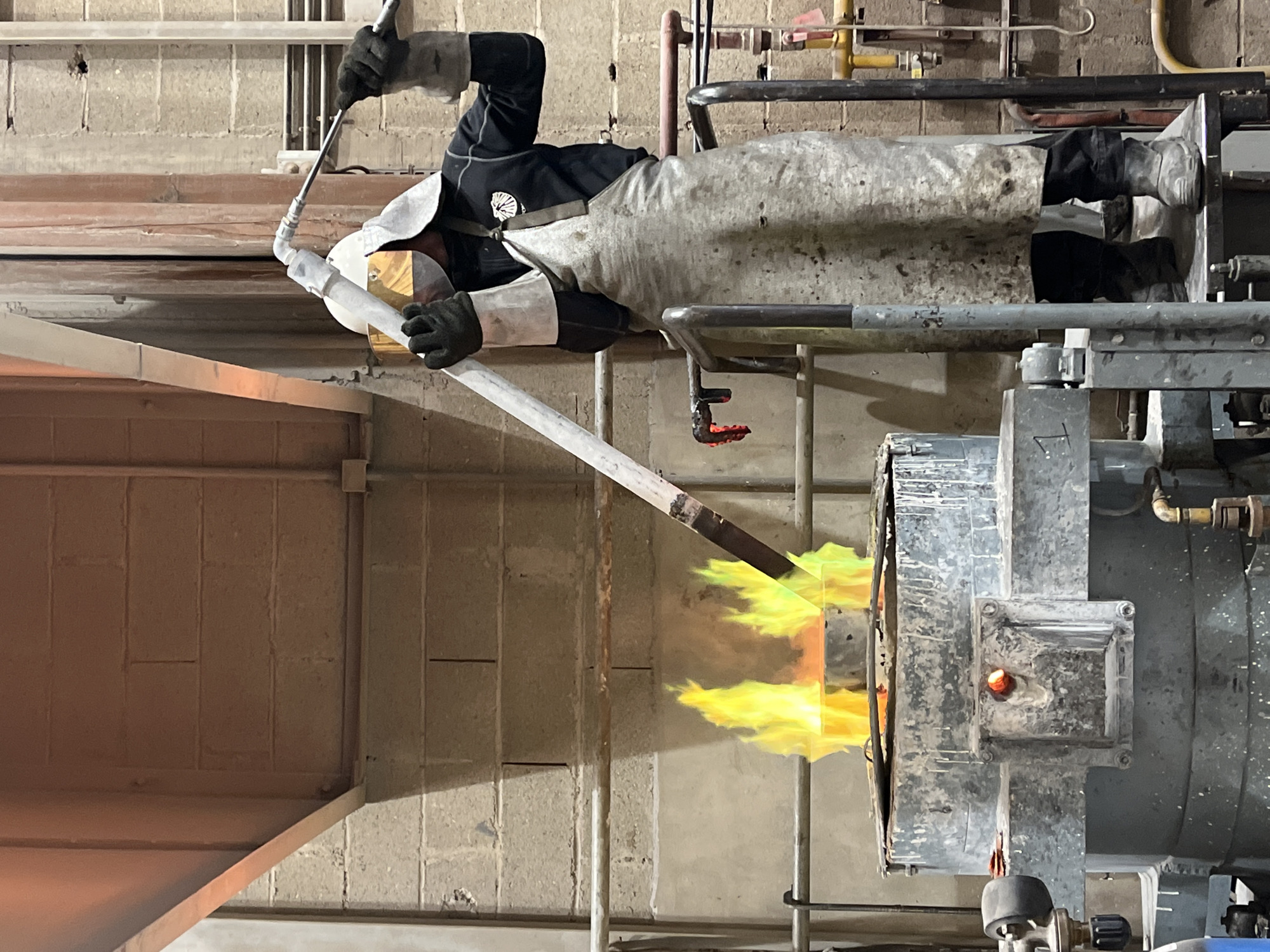 Worker conducts high-temperature operations in French industrial workshop