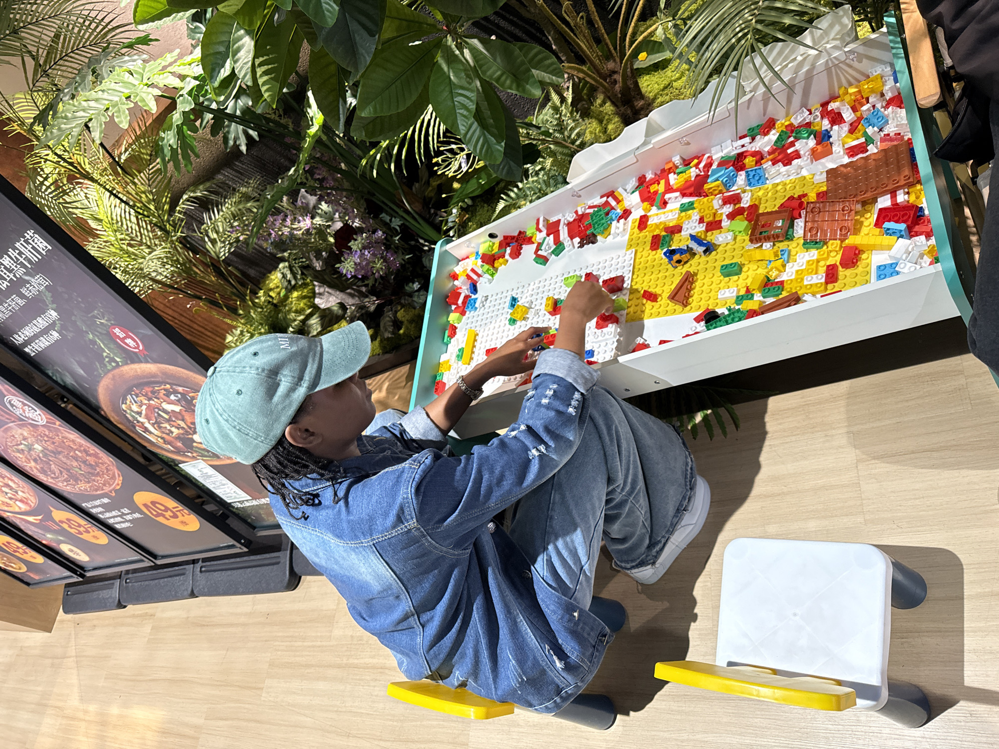 Person builds with Lego bricks indoors in Beijing