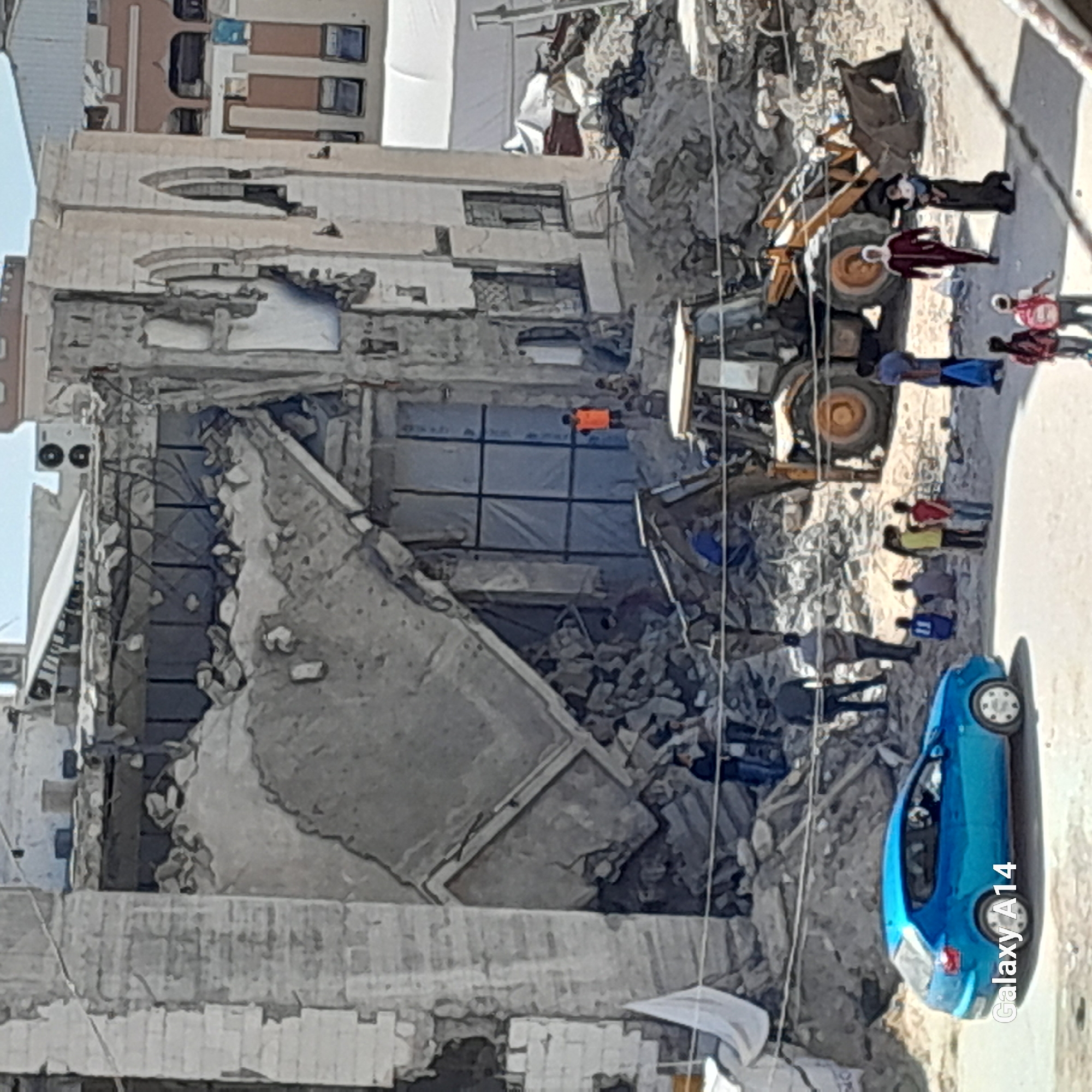 Cleanup crews work at collapsed building in Khan Yunis