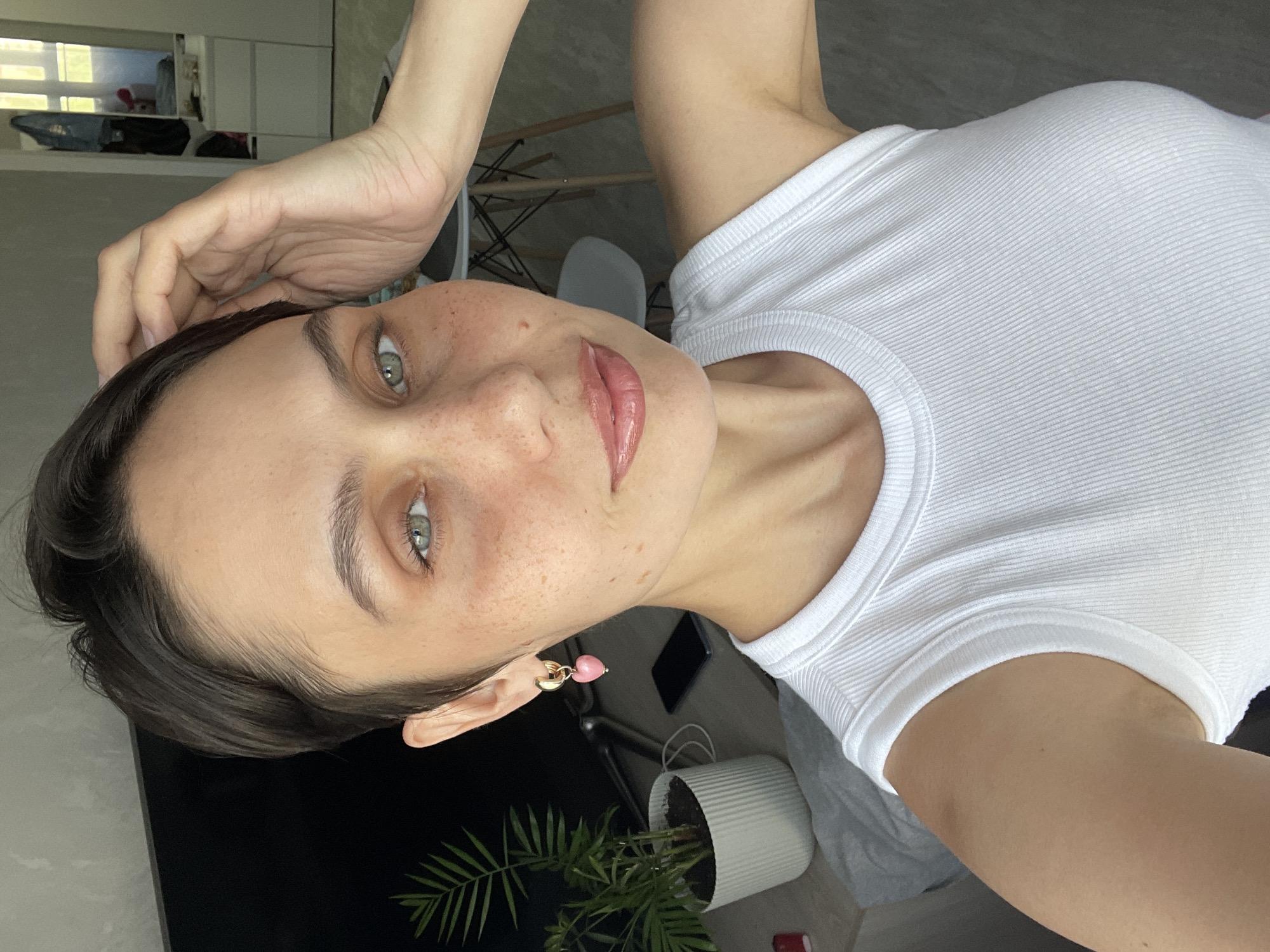 Woman takes morning selfies in bedroom in Izhevsk