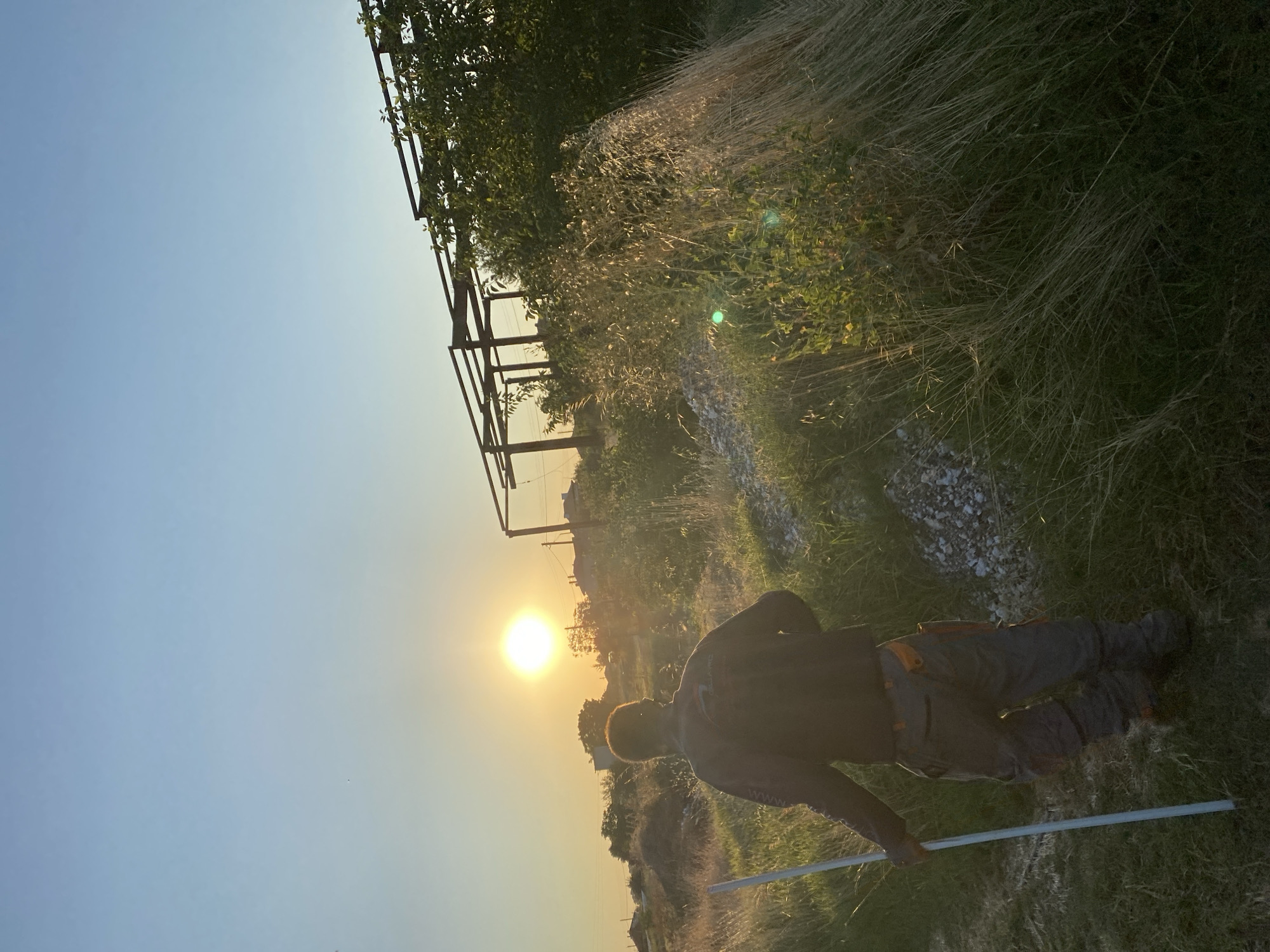 Walking into a golden sunset across Bulgarian fields