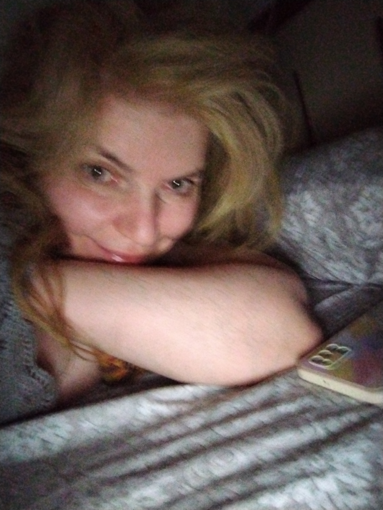 Person rests in bed with phone in UAE