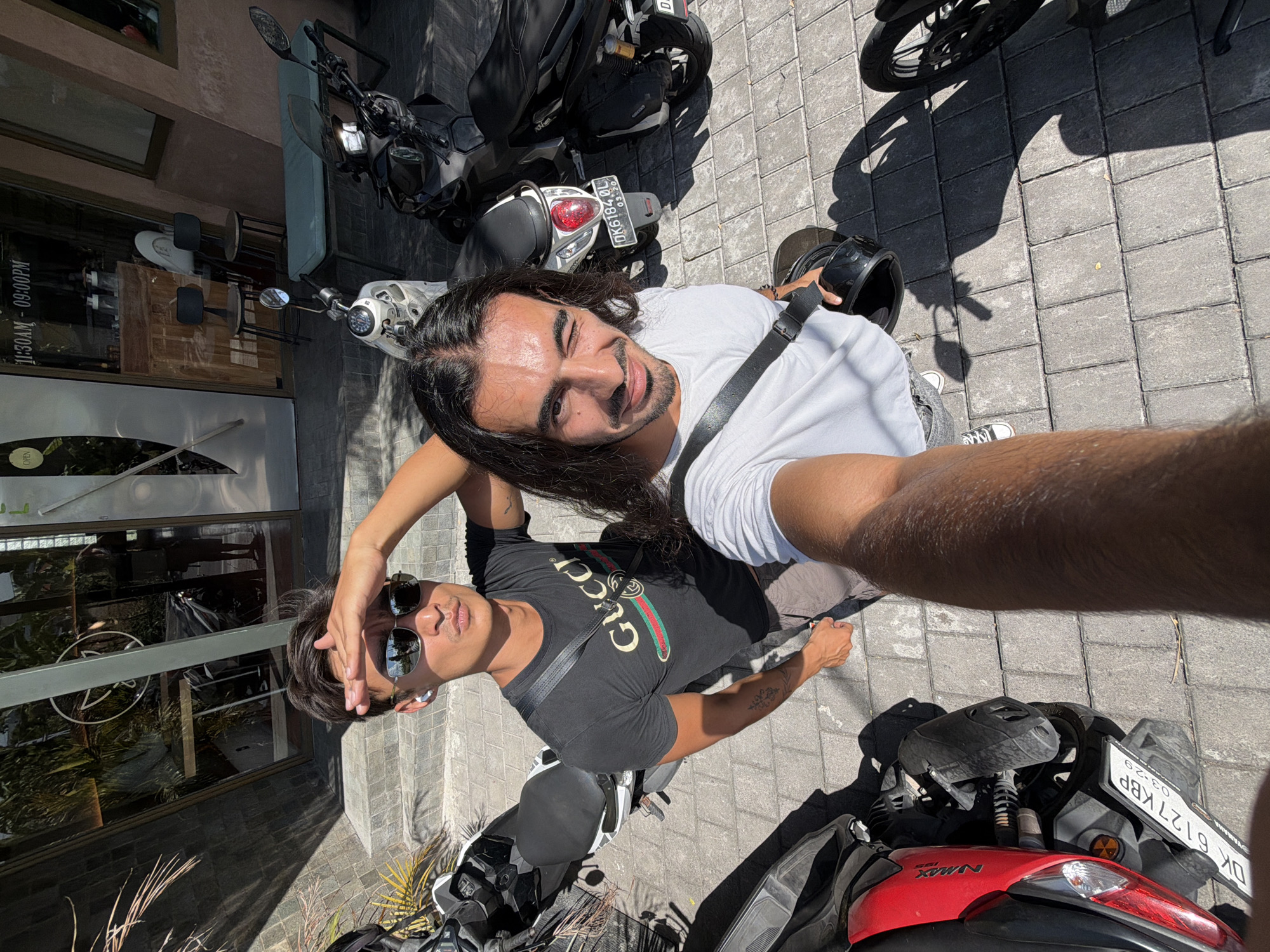 Two men photographed among motorbikes in North Kuta