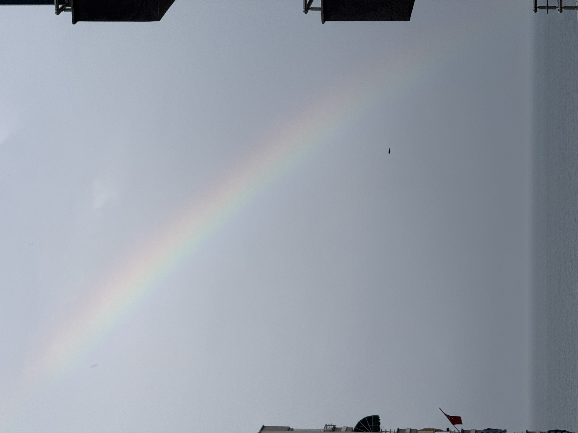 Rainbow appears over apartment buildings in Erdemli, Turkey