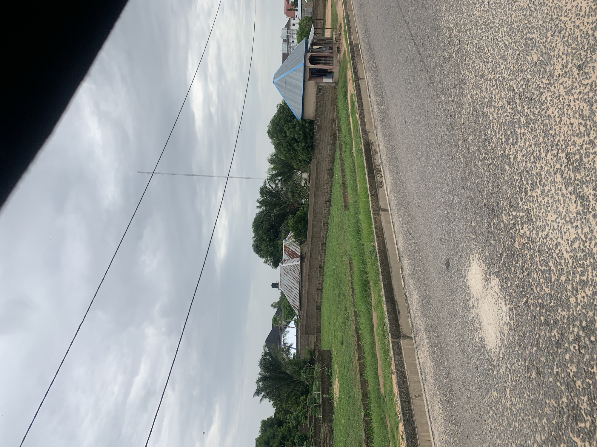 Street-level scenes around a school and event hall in Howayi, Nigeria