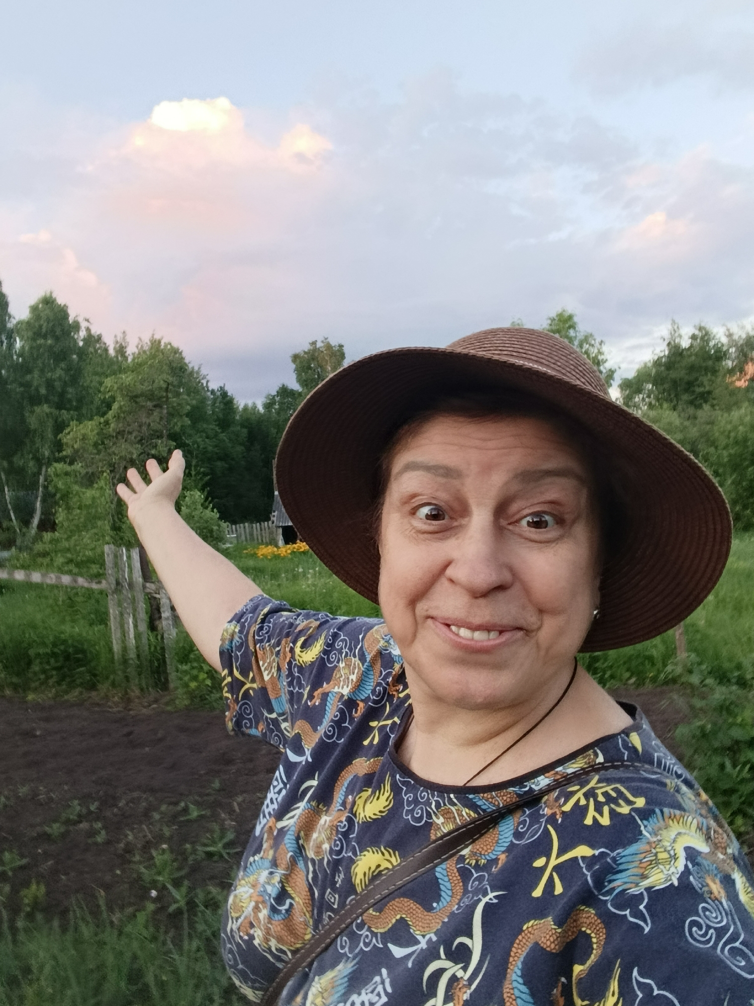 Woman takes cheerful selfies in garden setting in Verea