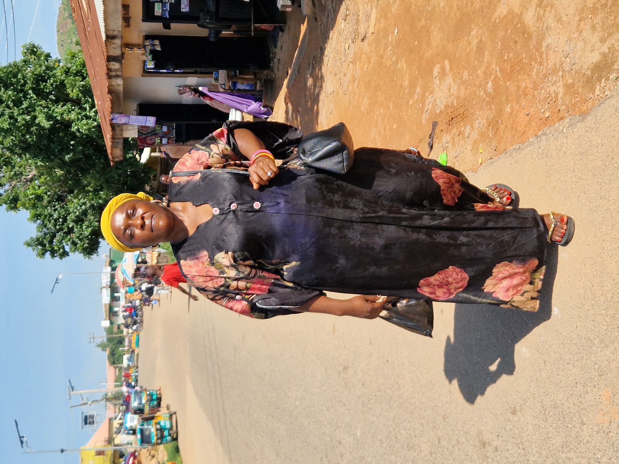 Everyday market activity along a dusty semi-urban street