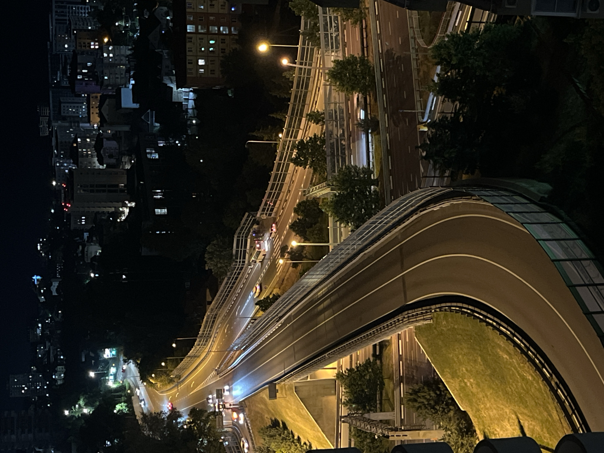 Nighttime aerial documentation of Sochi highway system and urban life