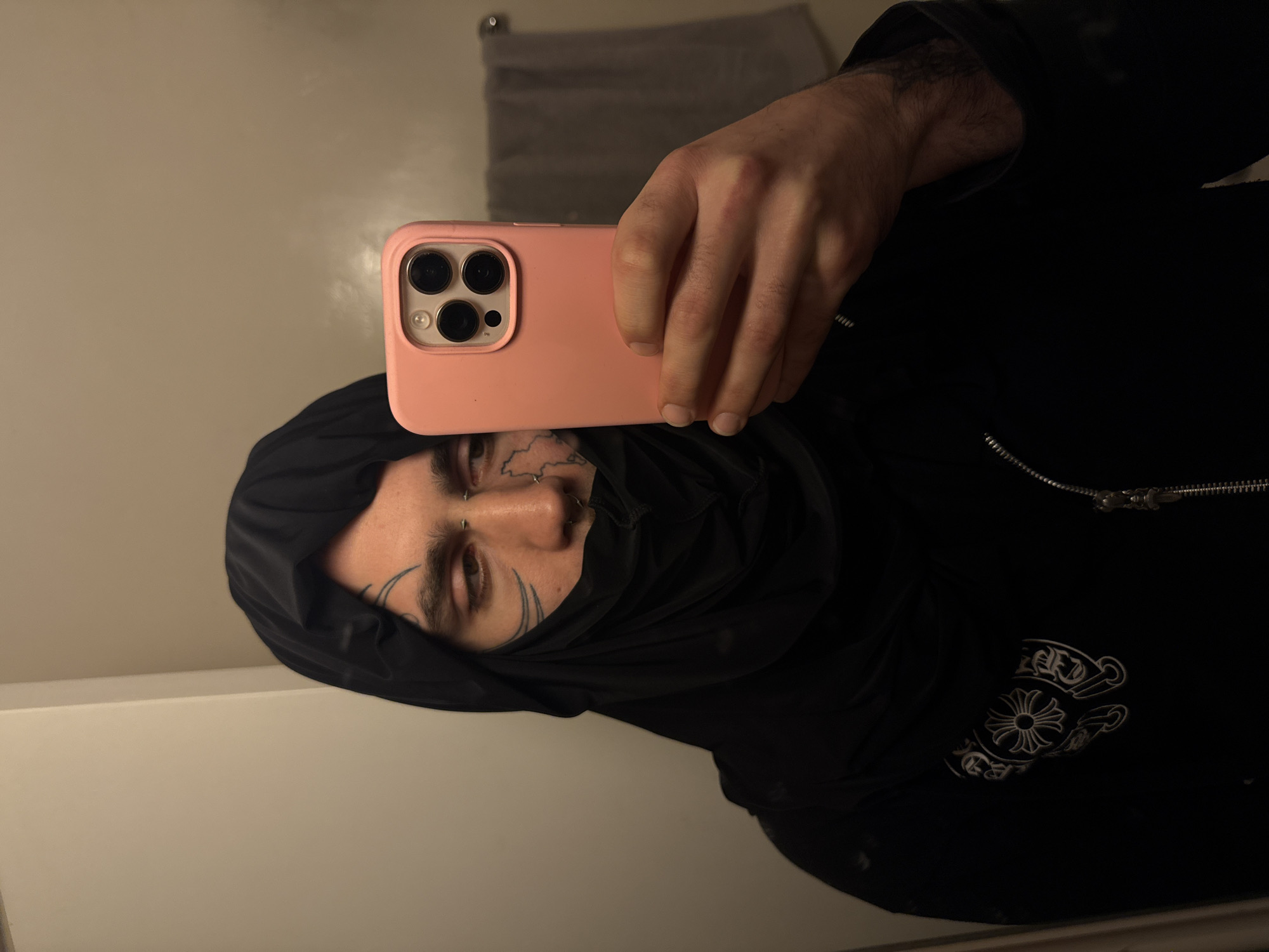 Tattooed individual takes indoor selfie in Buenos Aires