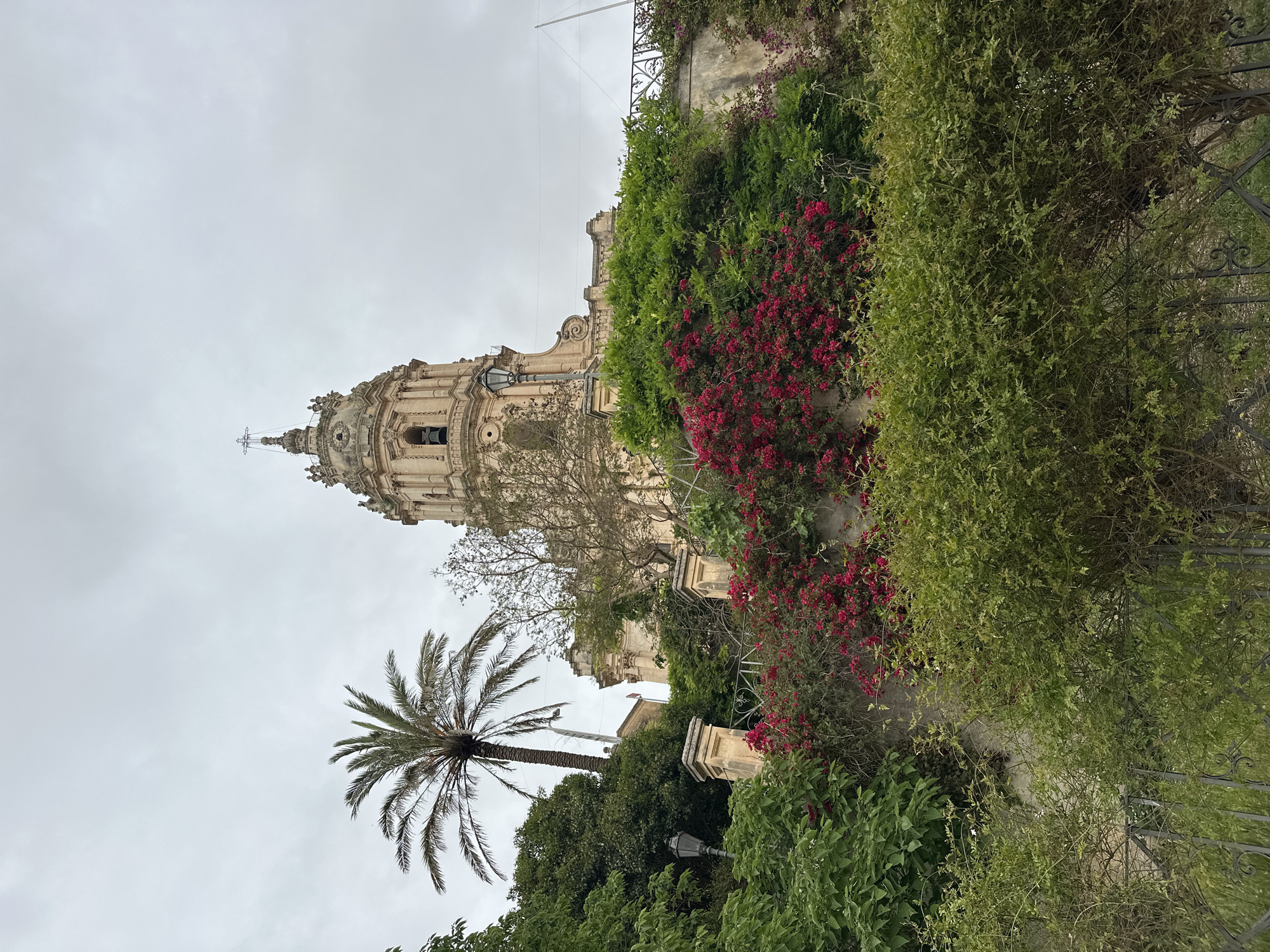 Tourist documents baroque cathedral and hillside views in Modica, Italy