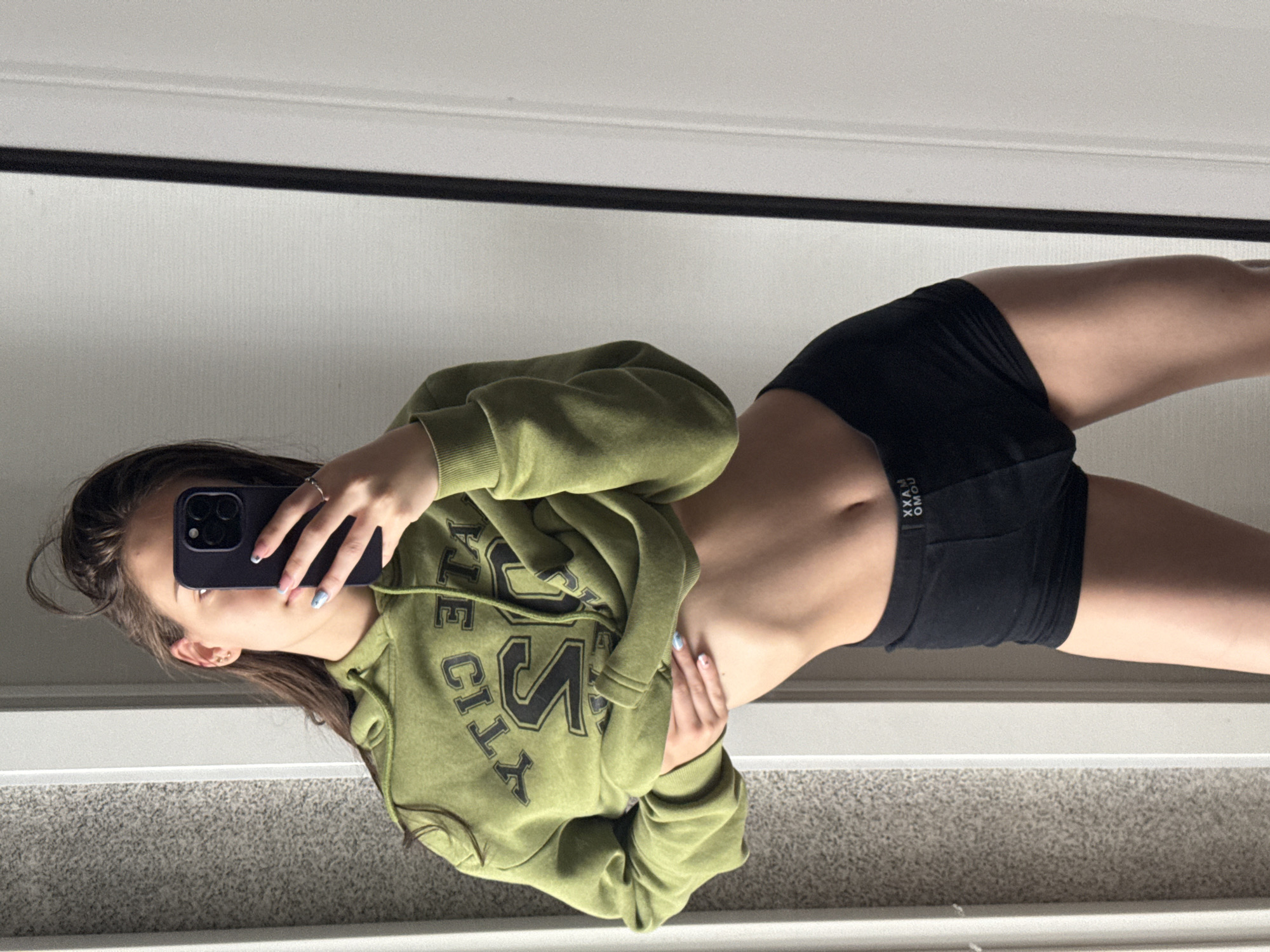 Young woman takes multiple mirror selfies in Sofia apartment