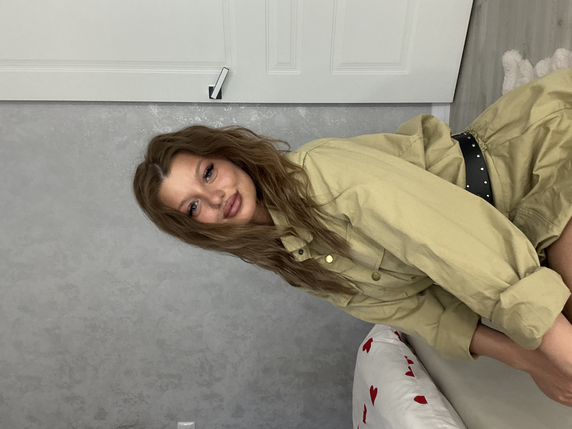 Woman photographs outfit changes in indoor Omsk session
