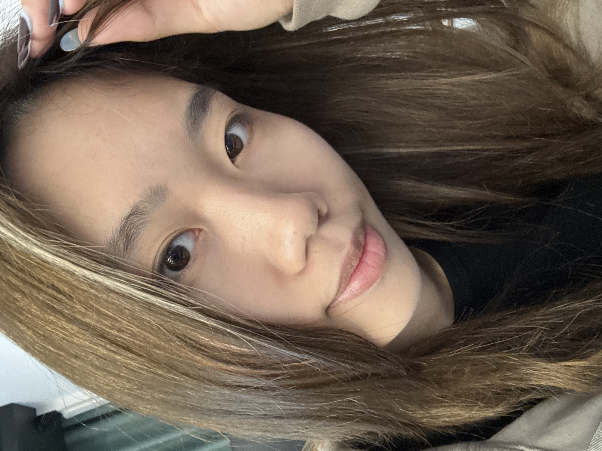 Young woman photographs herself indoors in Nan'an District
