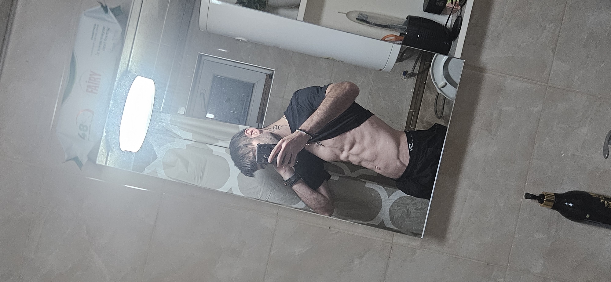 Man takes bathroom mirror selfies in Kostenets, Bulgaria