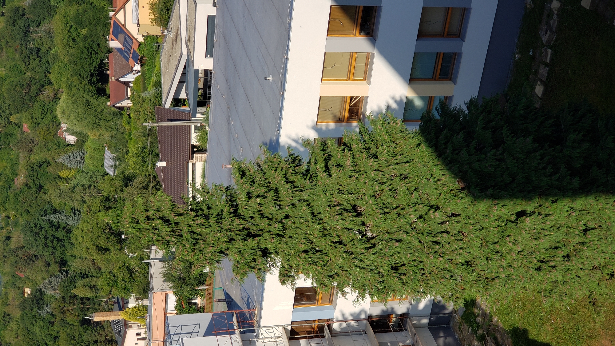 Prešov cityscape: construction, hillside neighborhoods, and summer greenery