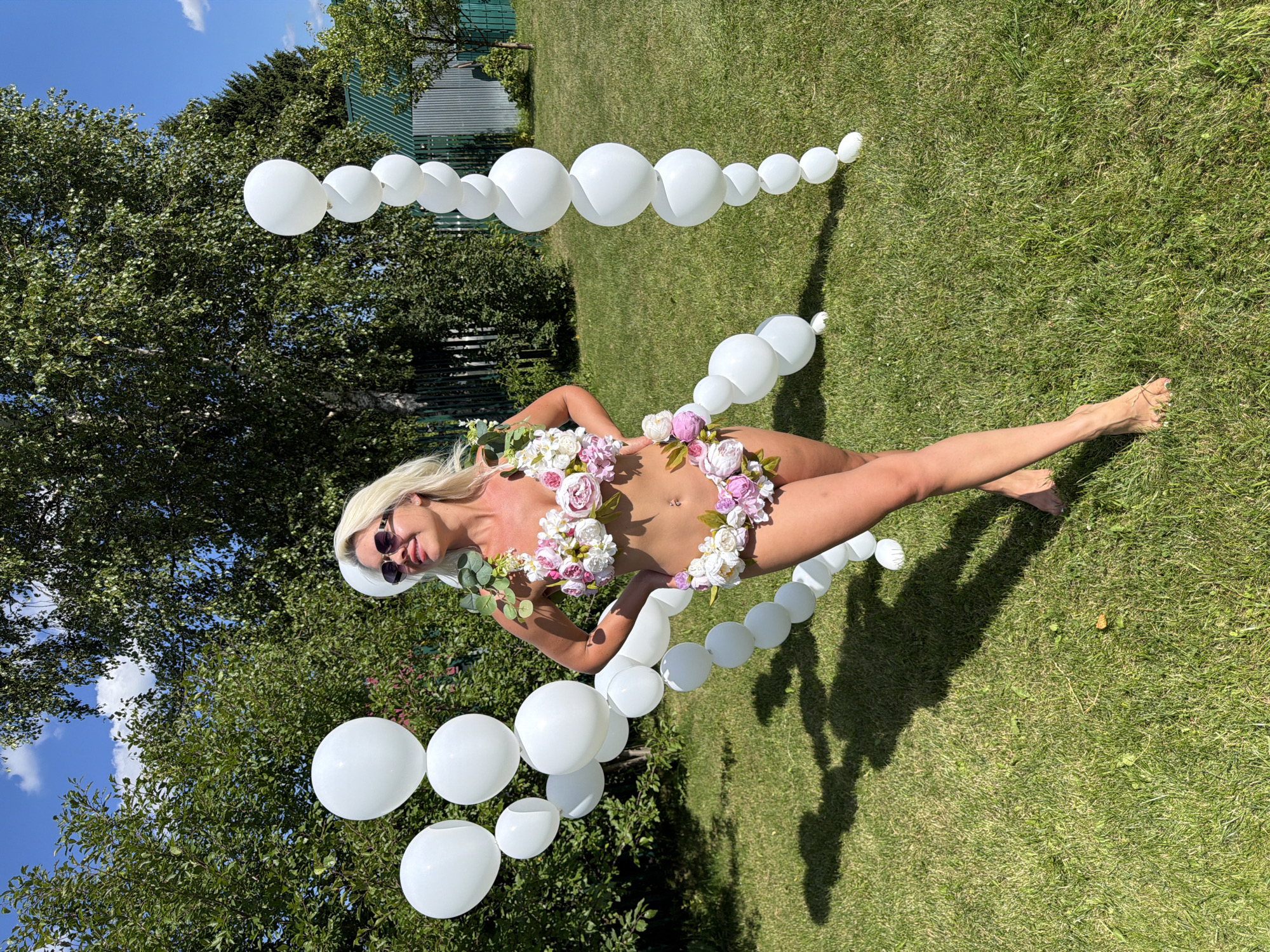 Floral bikini and balloon décor at an outdoor daytime event