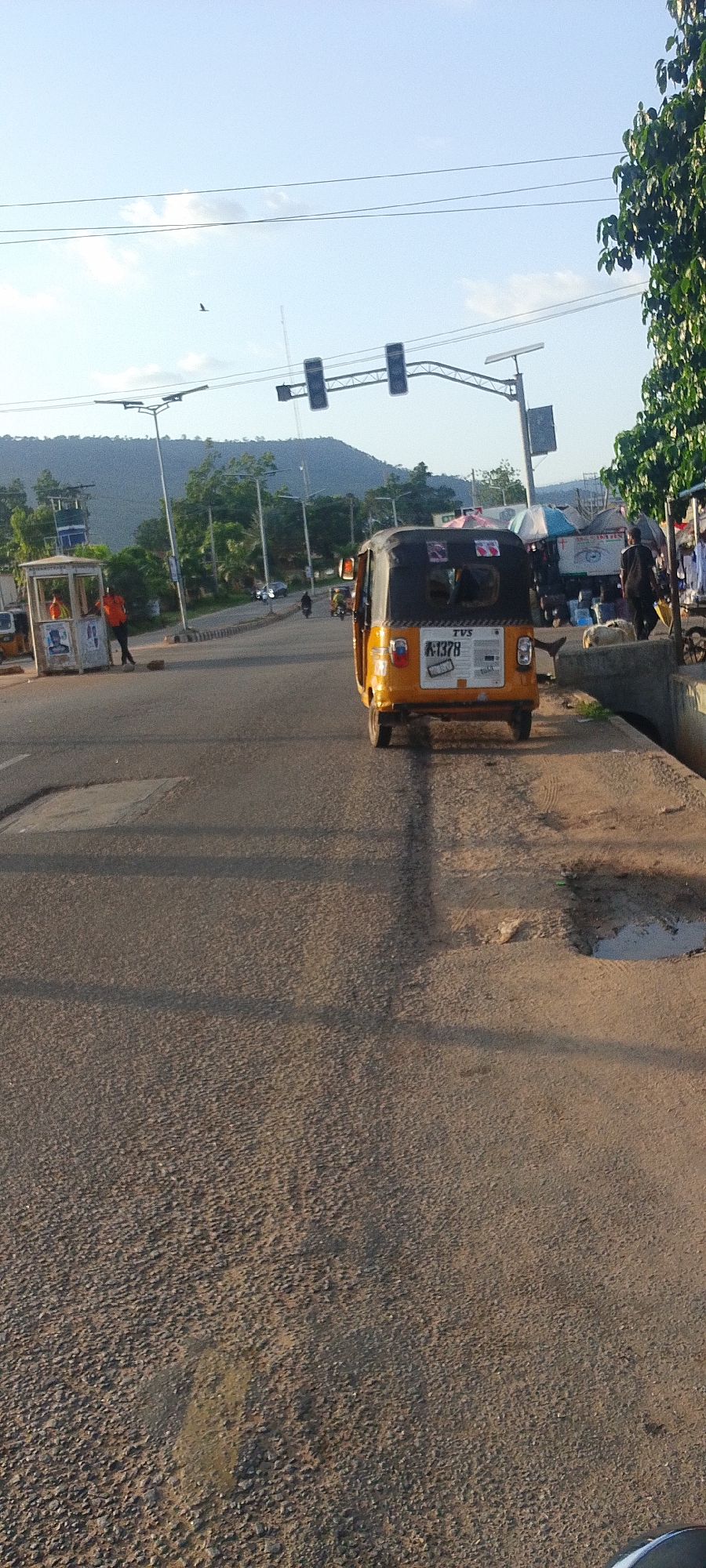 Auto-rickshaw spotted on Lokoja street under bright skies