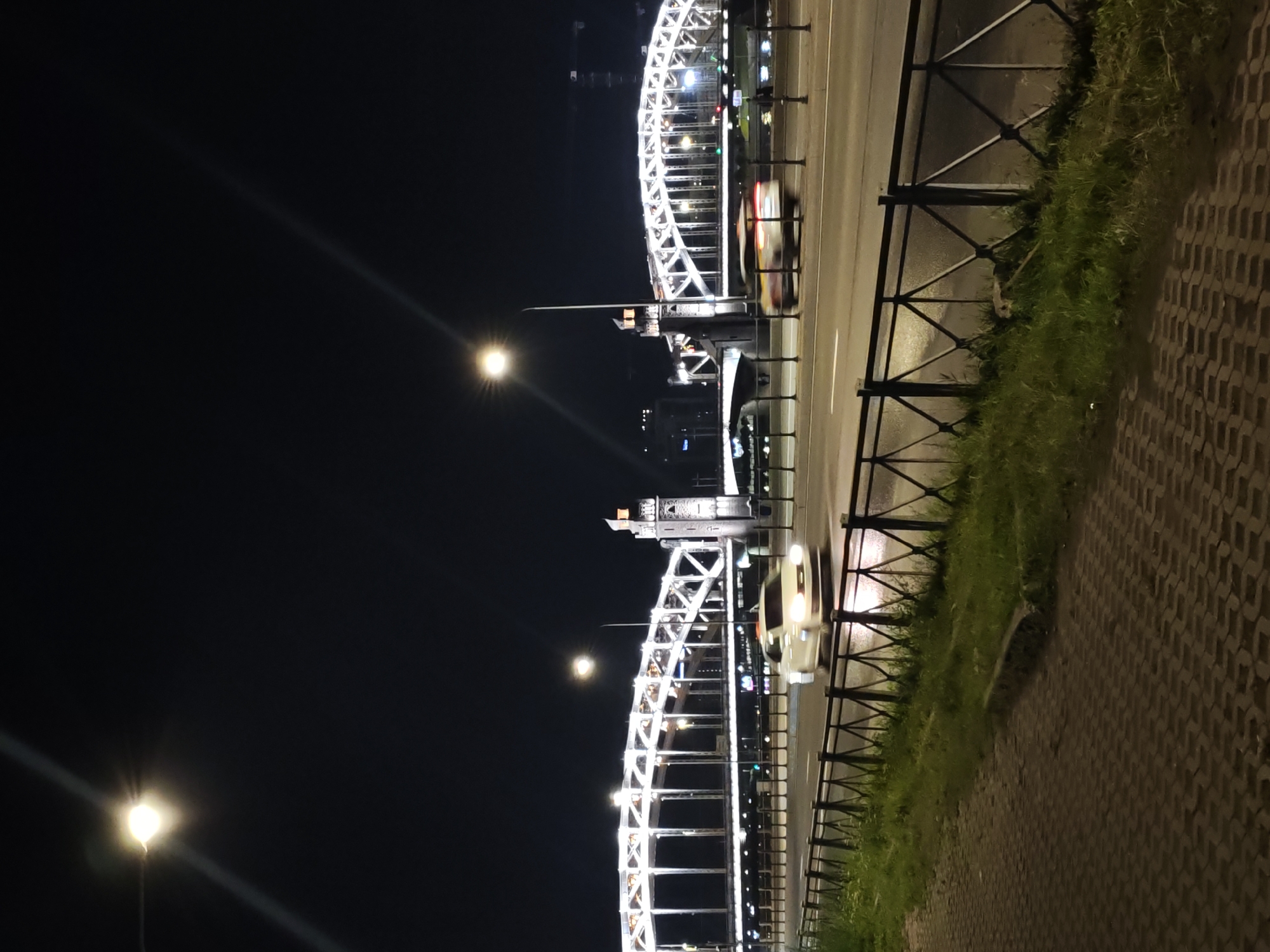 Saint Petersburg night: lit bridge and a DJ event indoors