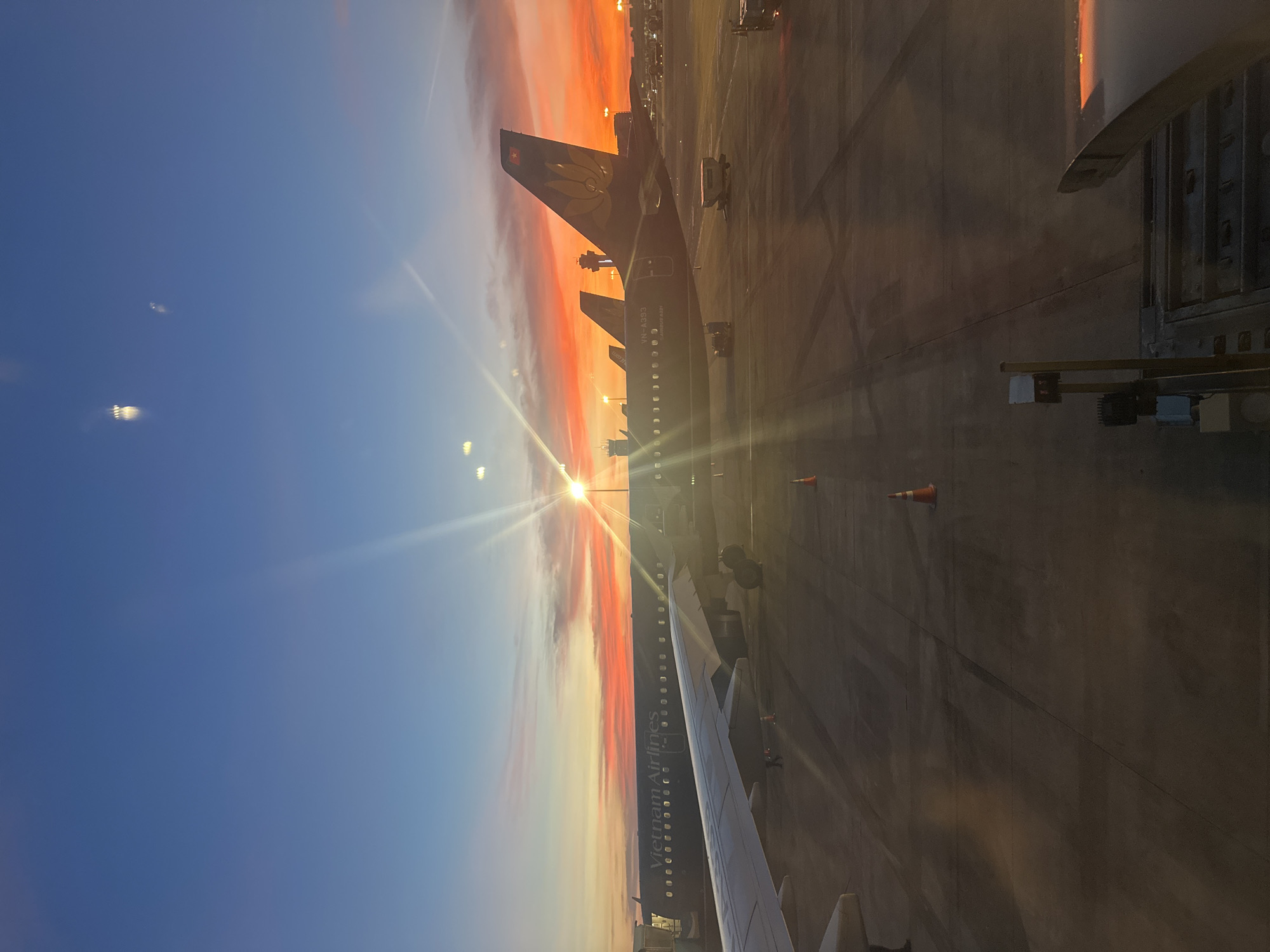 Vivid sunset colors over Thuận An airport tarmac