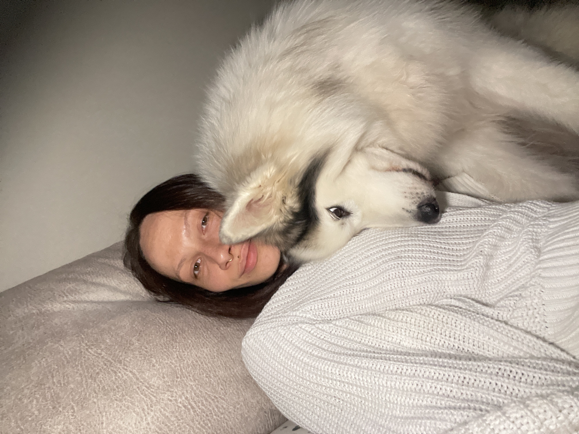 Woman and large white dog rest together in Izhevsk