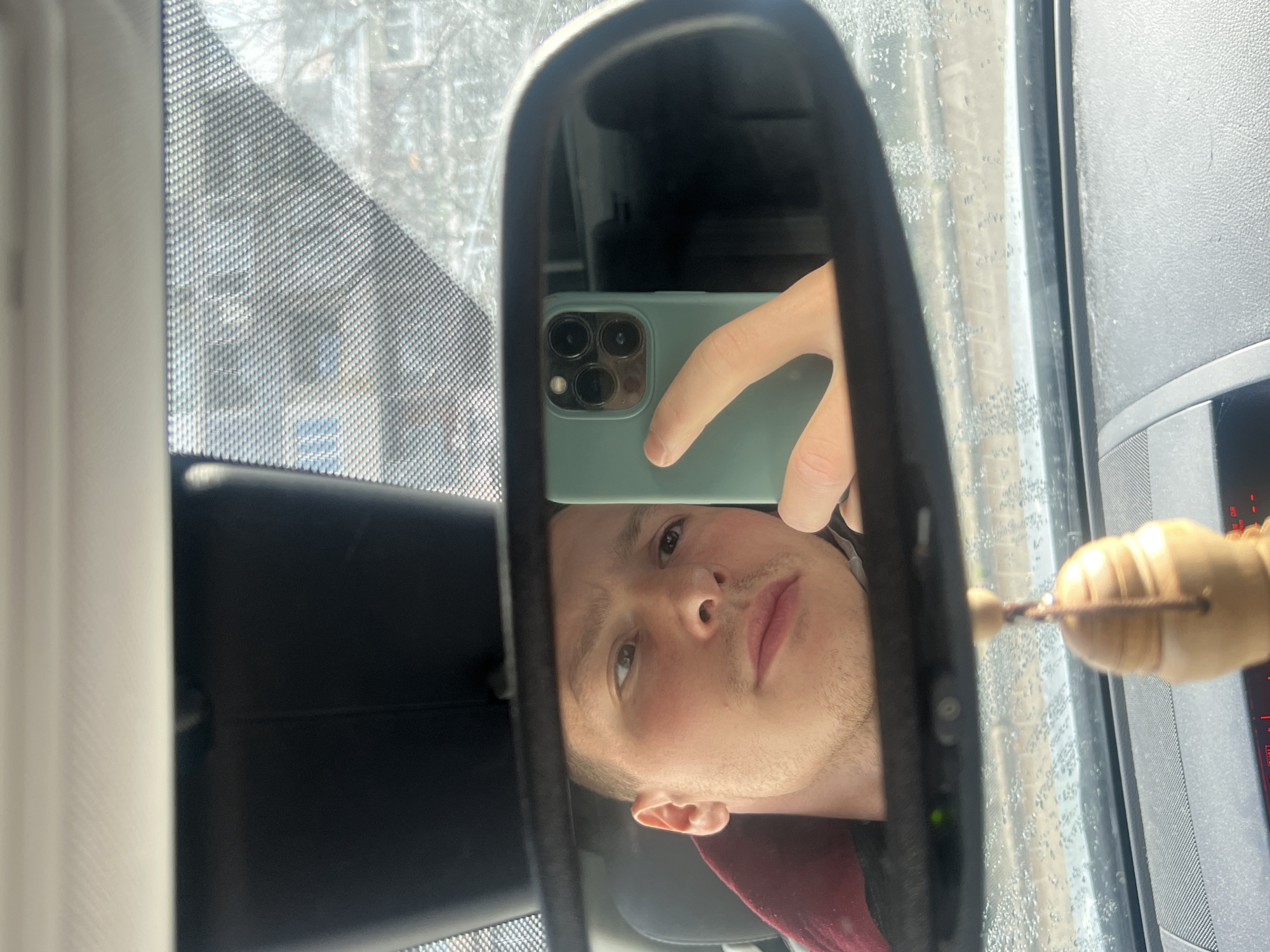 Person takes rearview mirror selfie in Burgas, Bulgaria