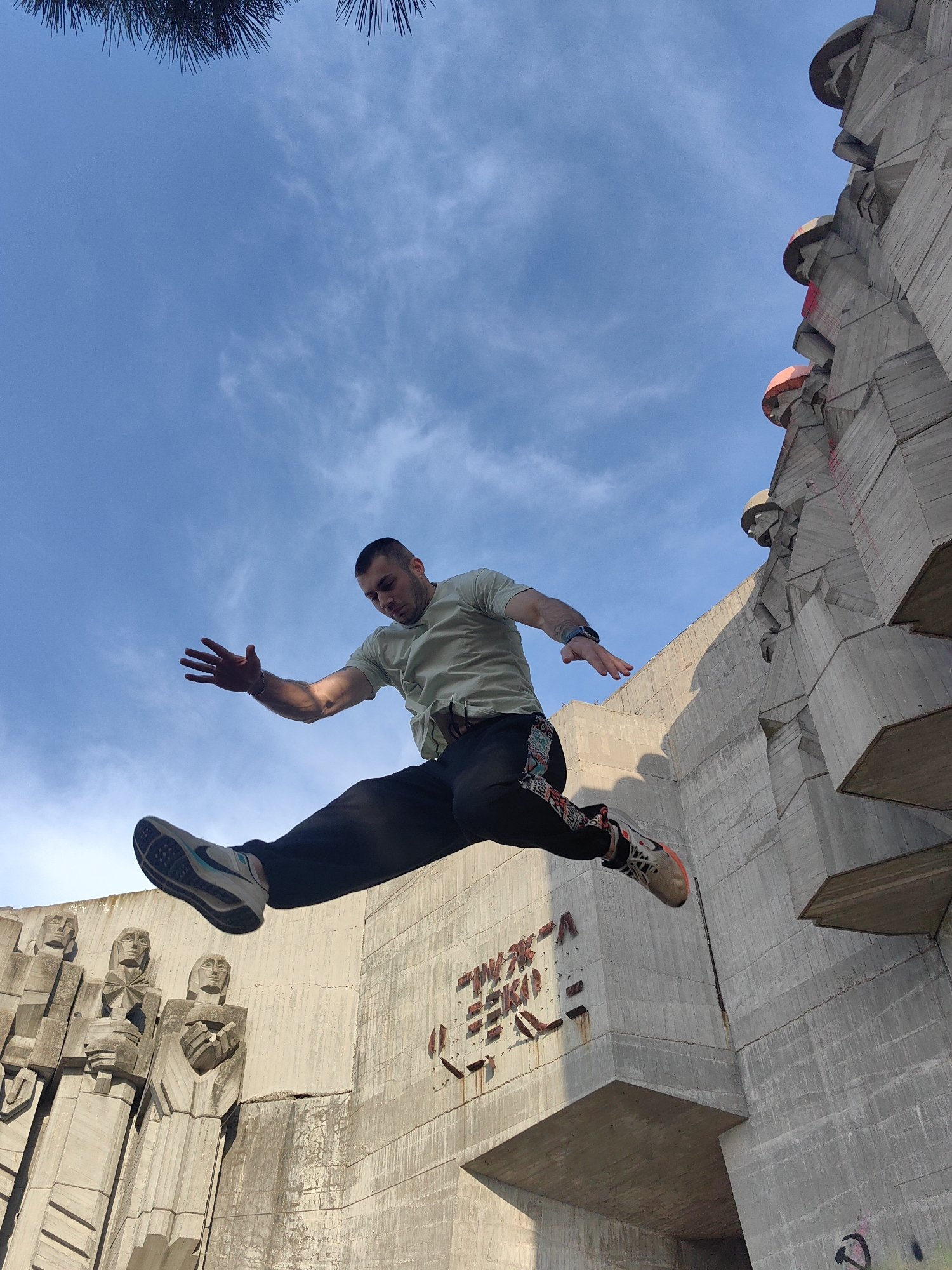 Man performs parkour stunts on concrete monument in Varna
