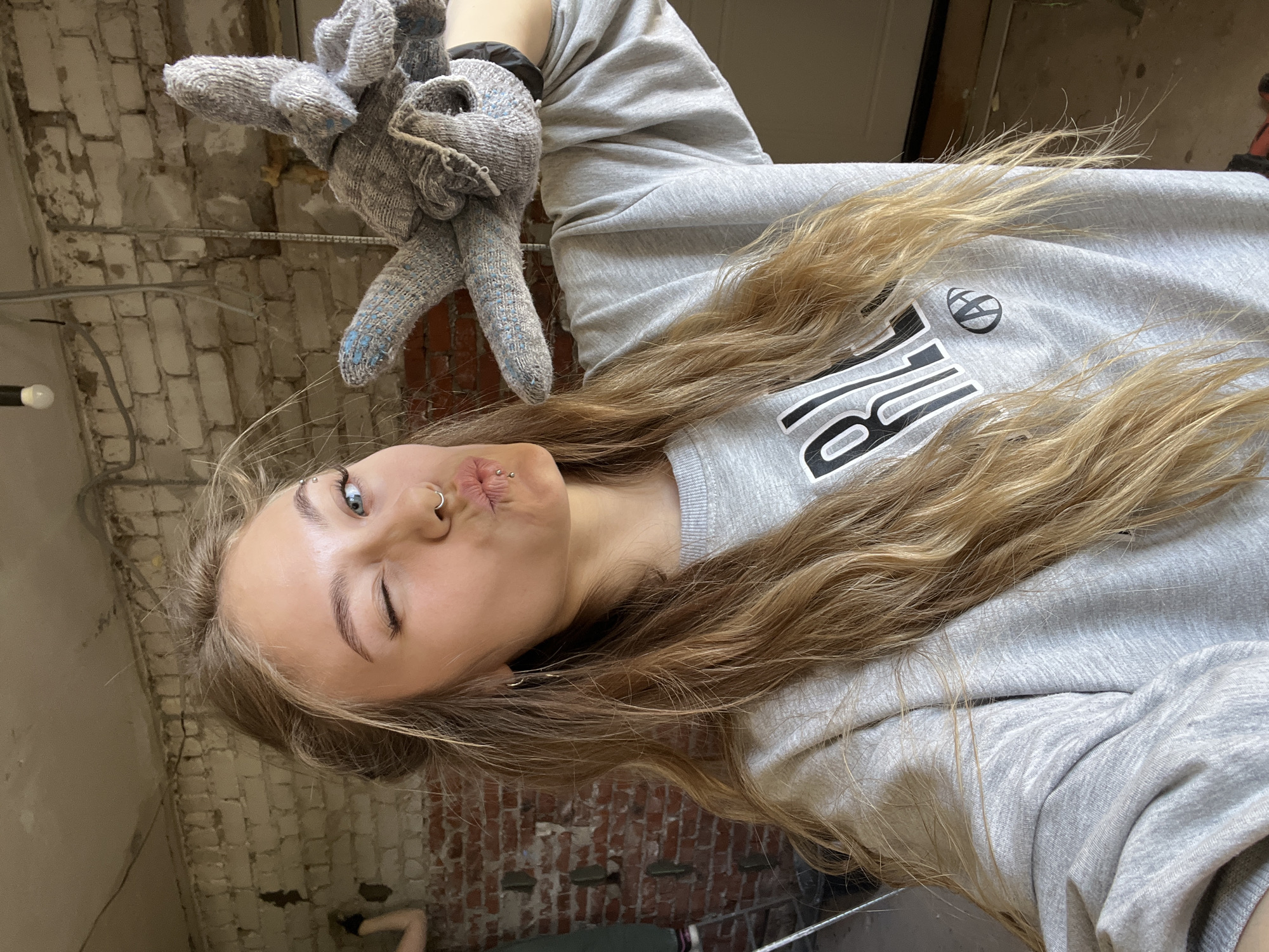 Woman with work gloves photographed indoors in Foki, Russia